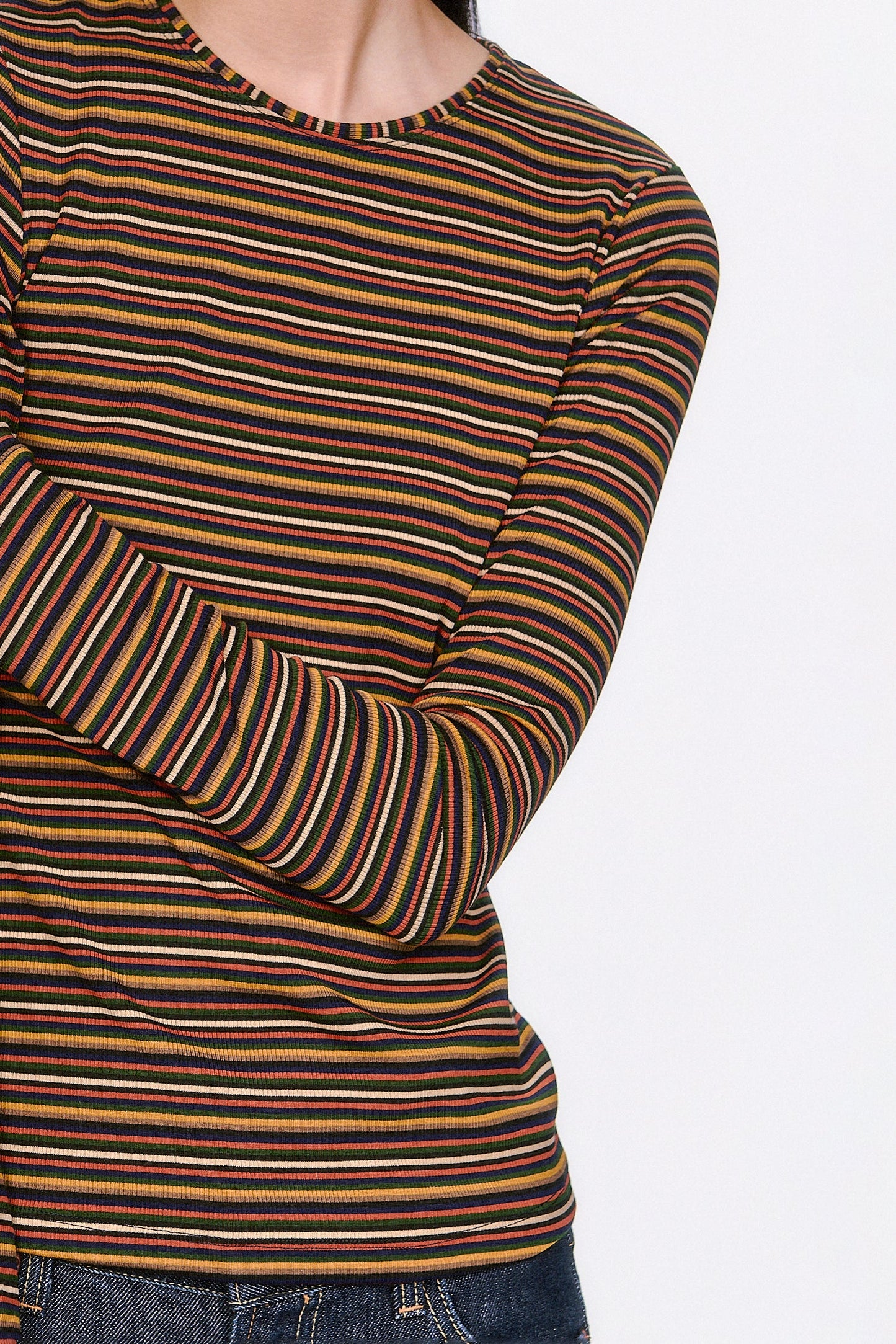 Close-up of a person wearing a Venetian multicolored caramel Stripe Long Sleeve, round collar cut.