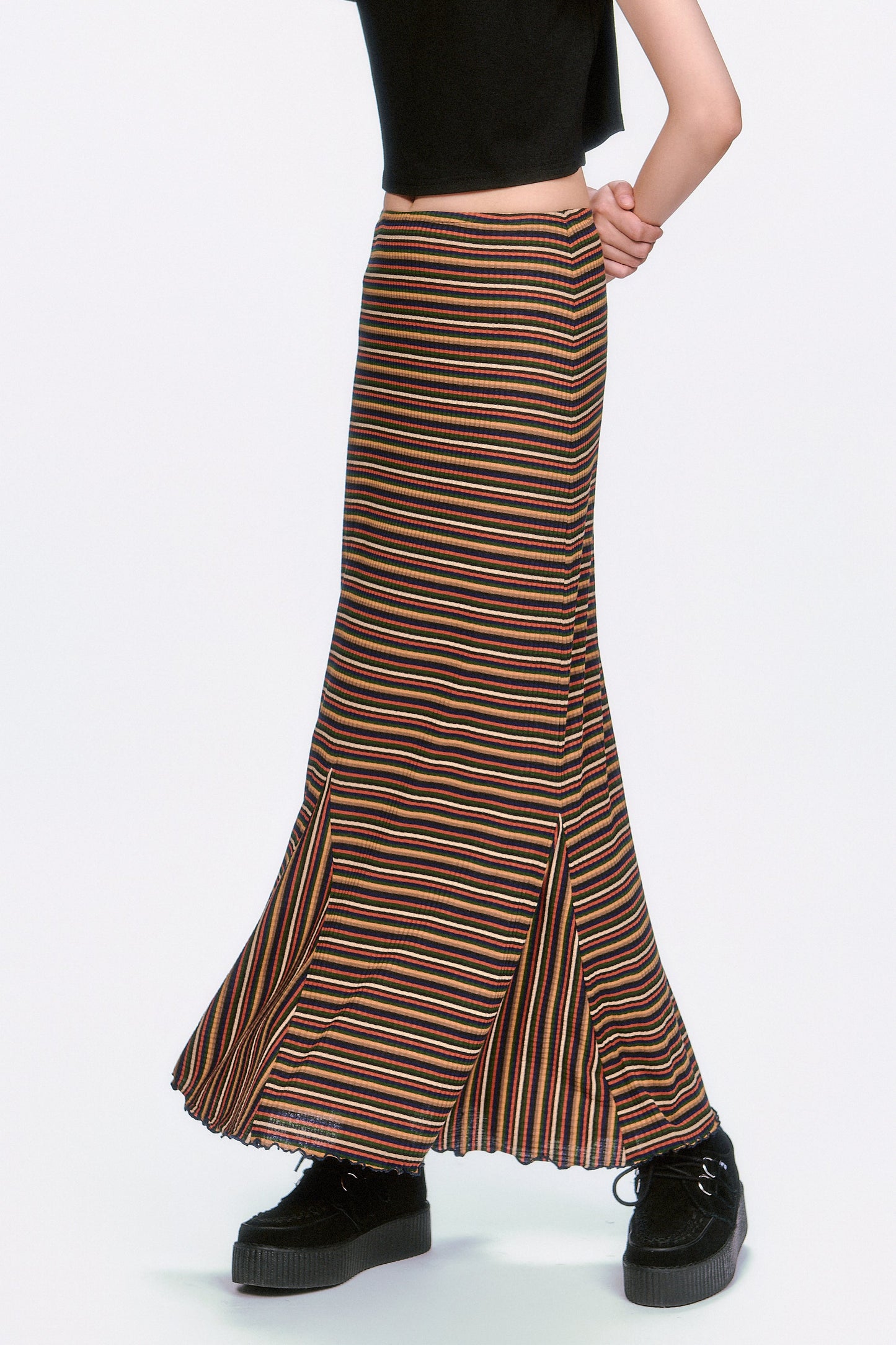 Person wearing a Venetian Skirt, featuring multicolored caramel lines with 2 slits to ease the walk