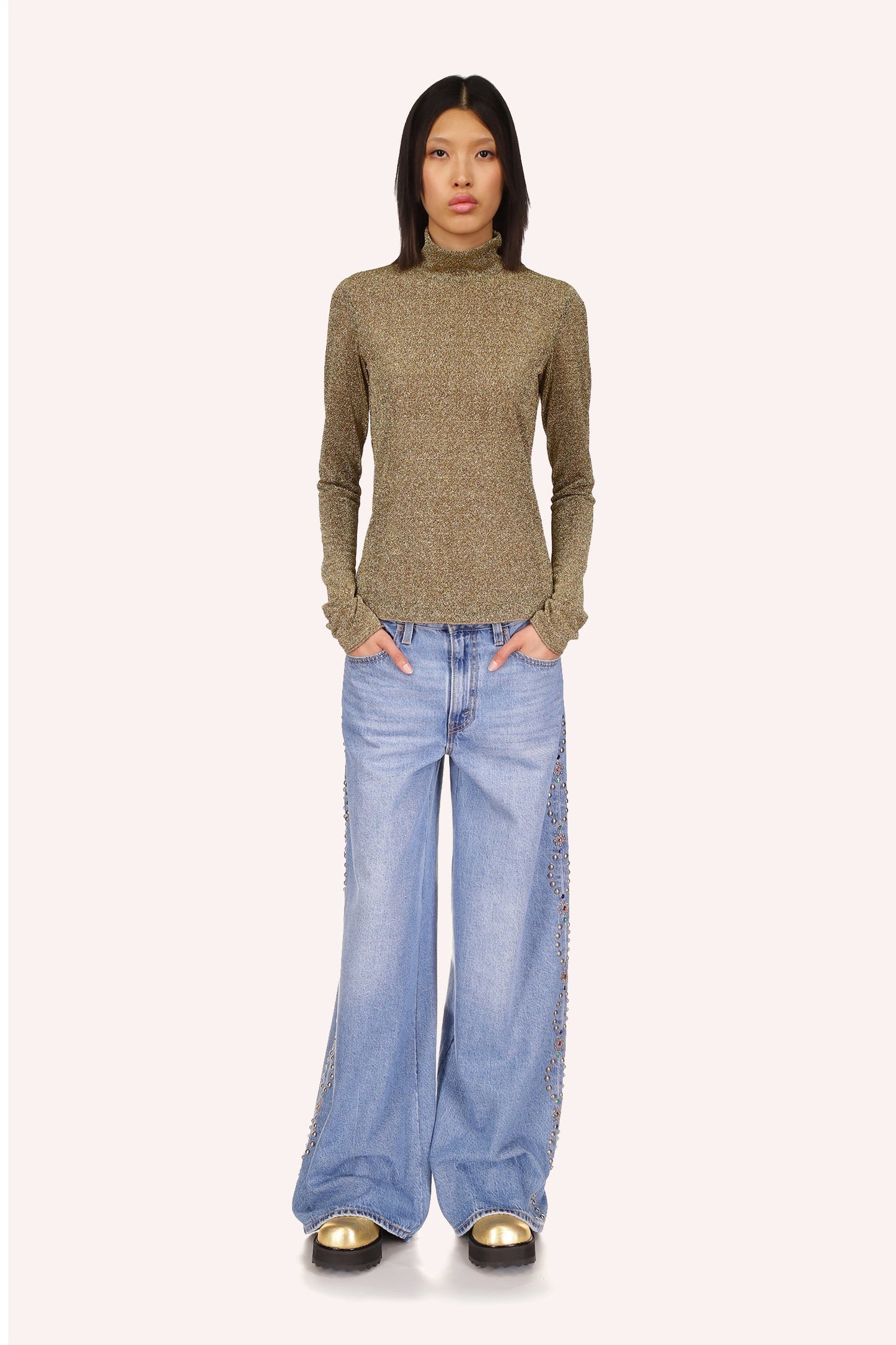 Sparkling gold color and turtleneck, features very long sleeves that can be worn over the hands