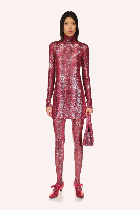 The Snakeskin Sequin Turtleneck is a shiny mini dress, featuring a ruby red color, long sleeves