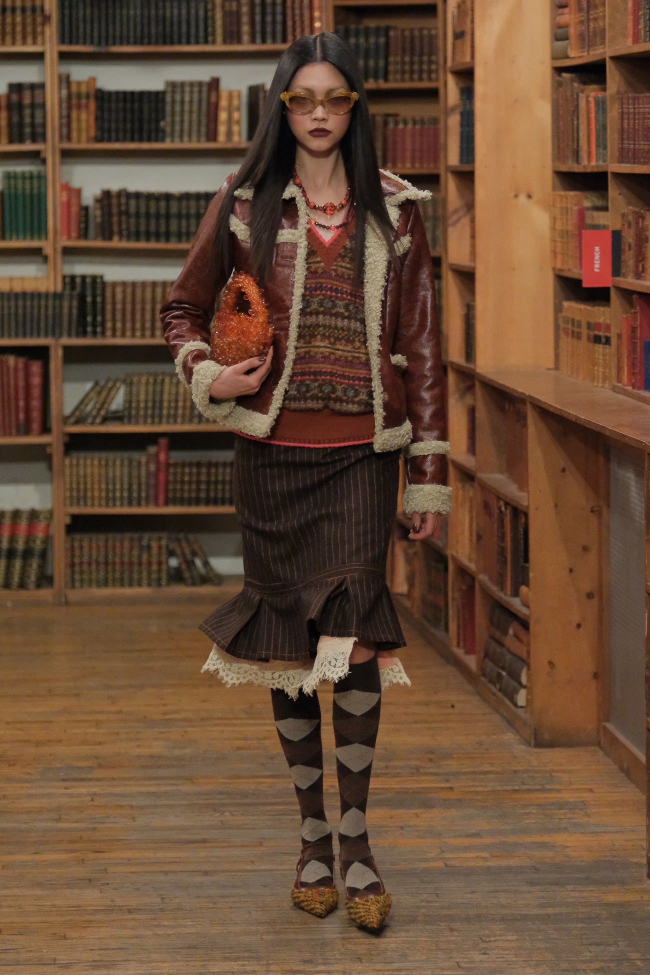 In a library setting, Fair Isle Fleece Vest, sleeveless, v-cut collar perfect pair with dark dress.