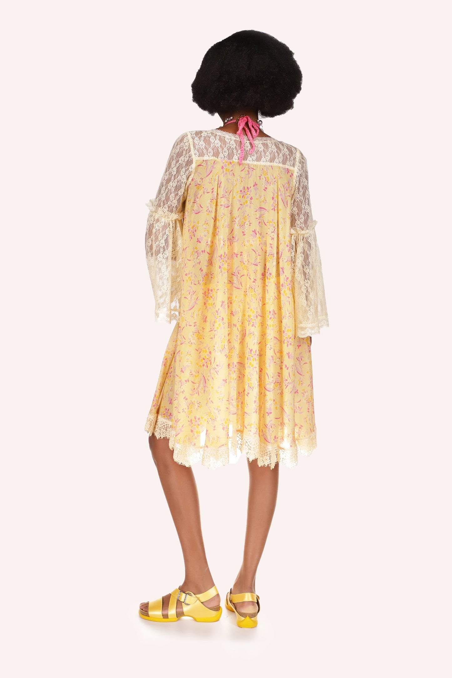 Arcadia Blossom Cover Up is in yellow color at center, arms are laced see-thru, with red print