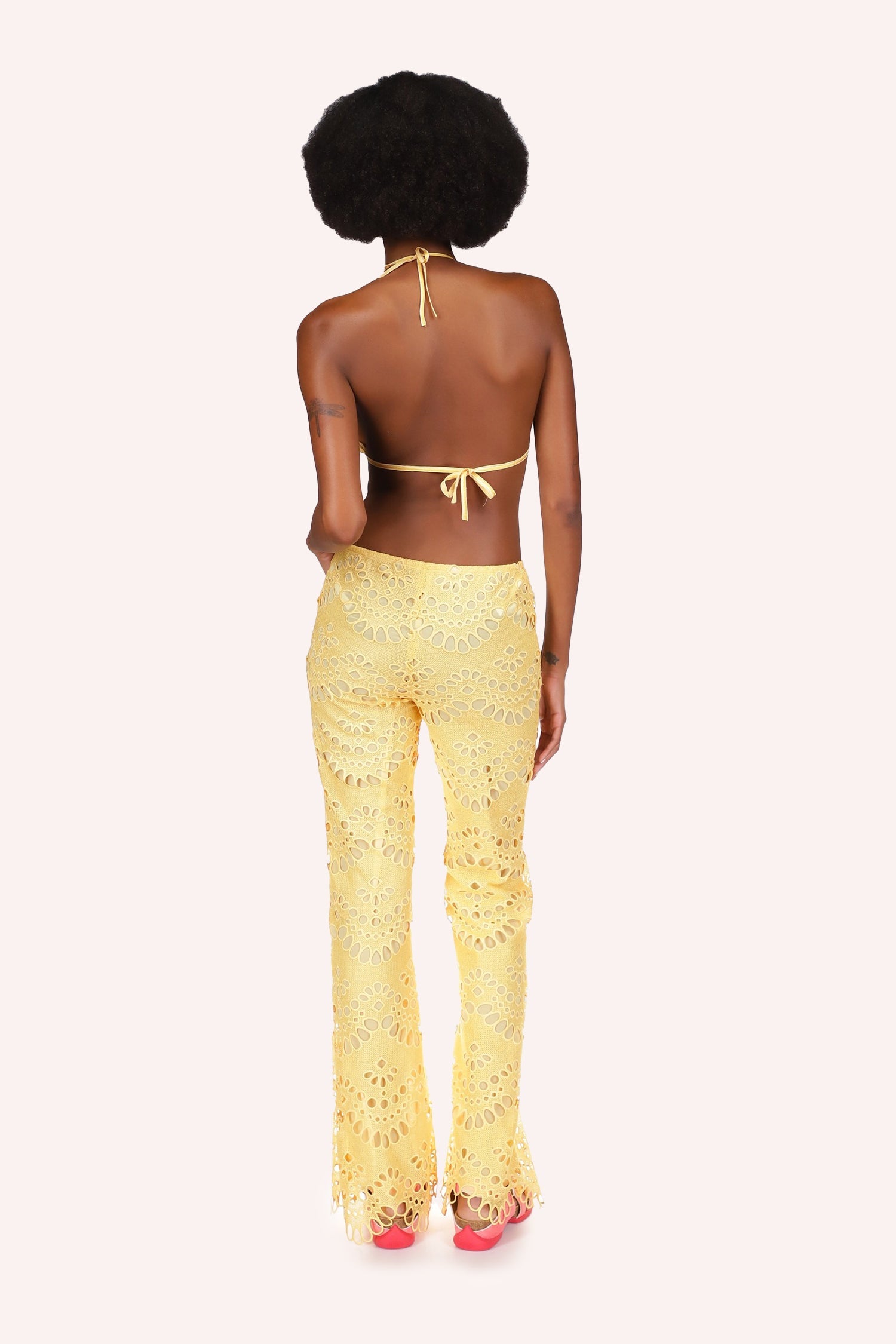 Back of Eyelet Pants yellow with from small to large oval eyelets in a round shaped alignment