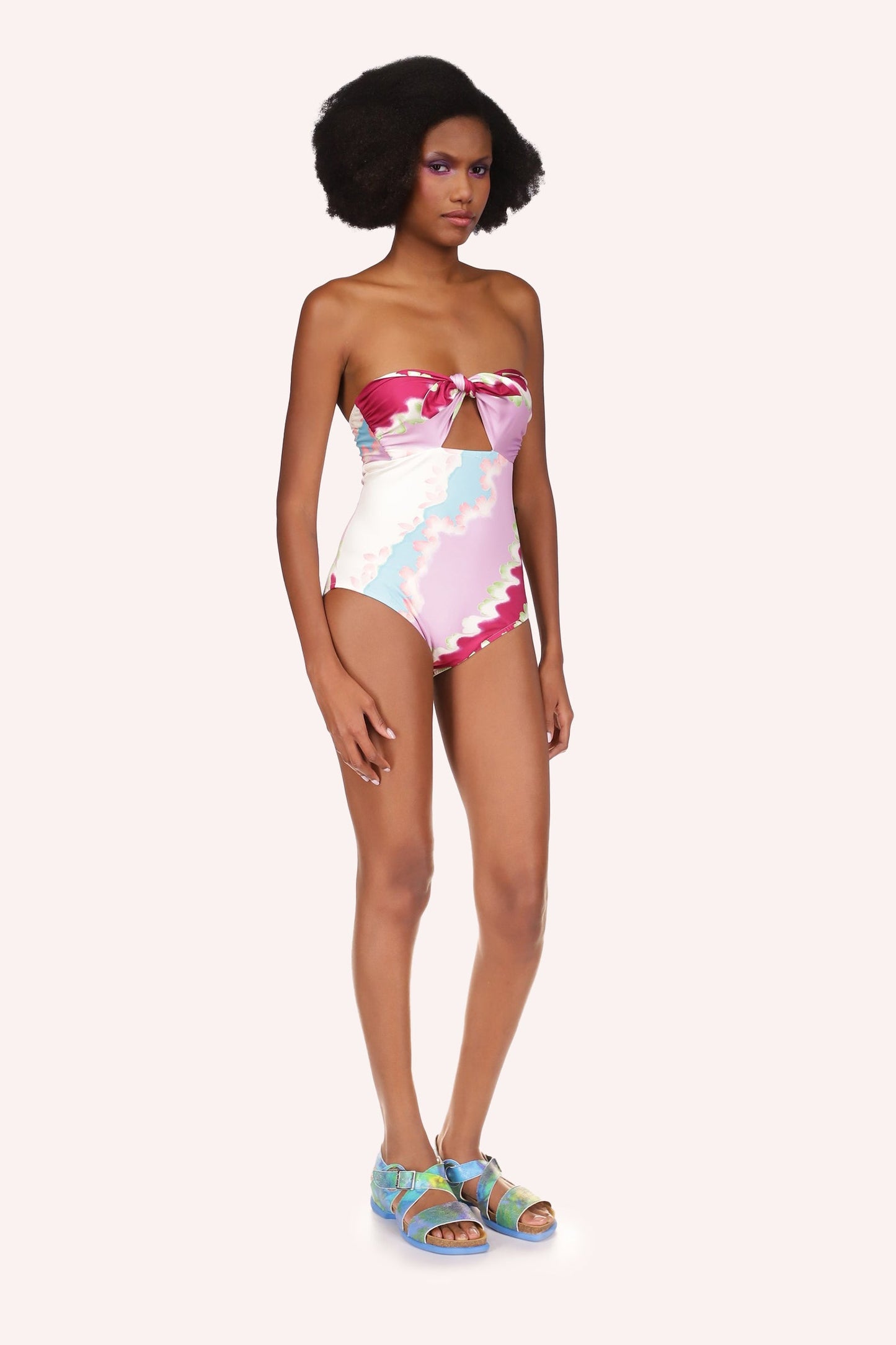 In a stretch fabric, full Bathing Suit wavy lines cloudy design in red, white, pink, and blue