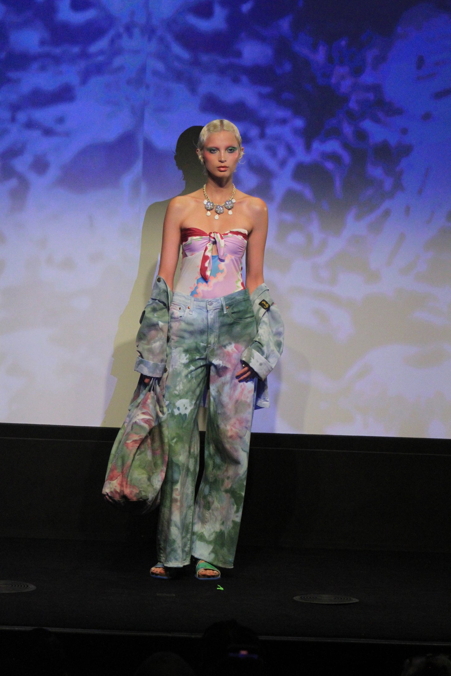 Under runway lights, Ocean Tie Dye Jacket, green floral design with touch of pink.