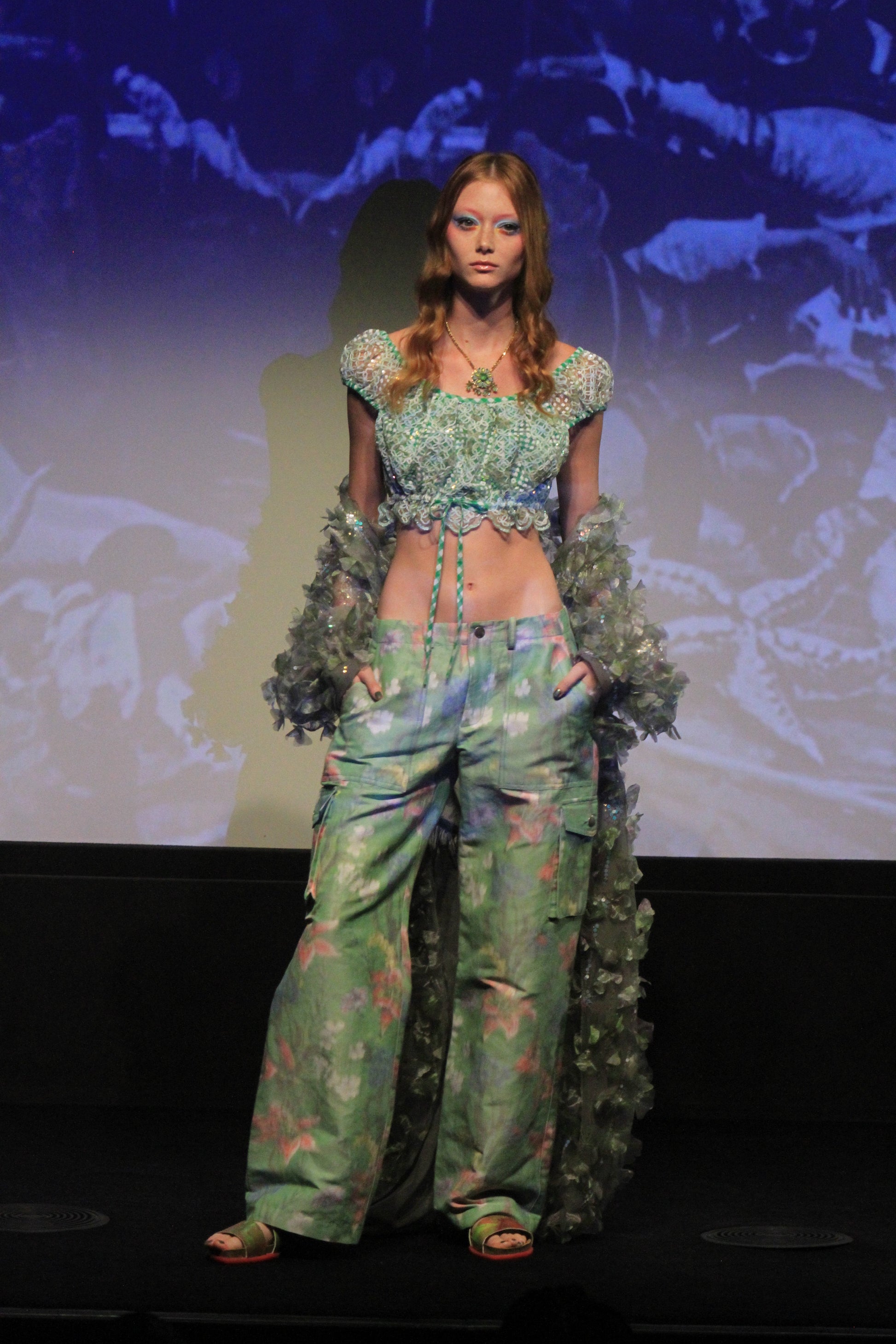 On runway light, Gingham Top, light green with a green pants, and a fluffy boa