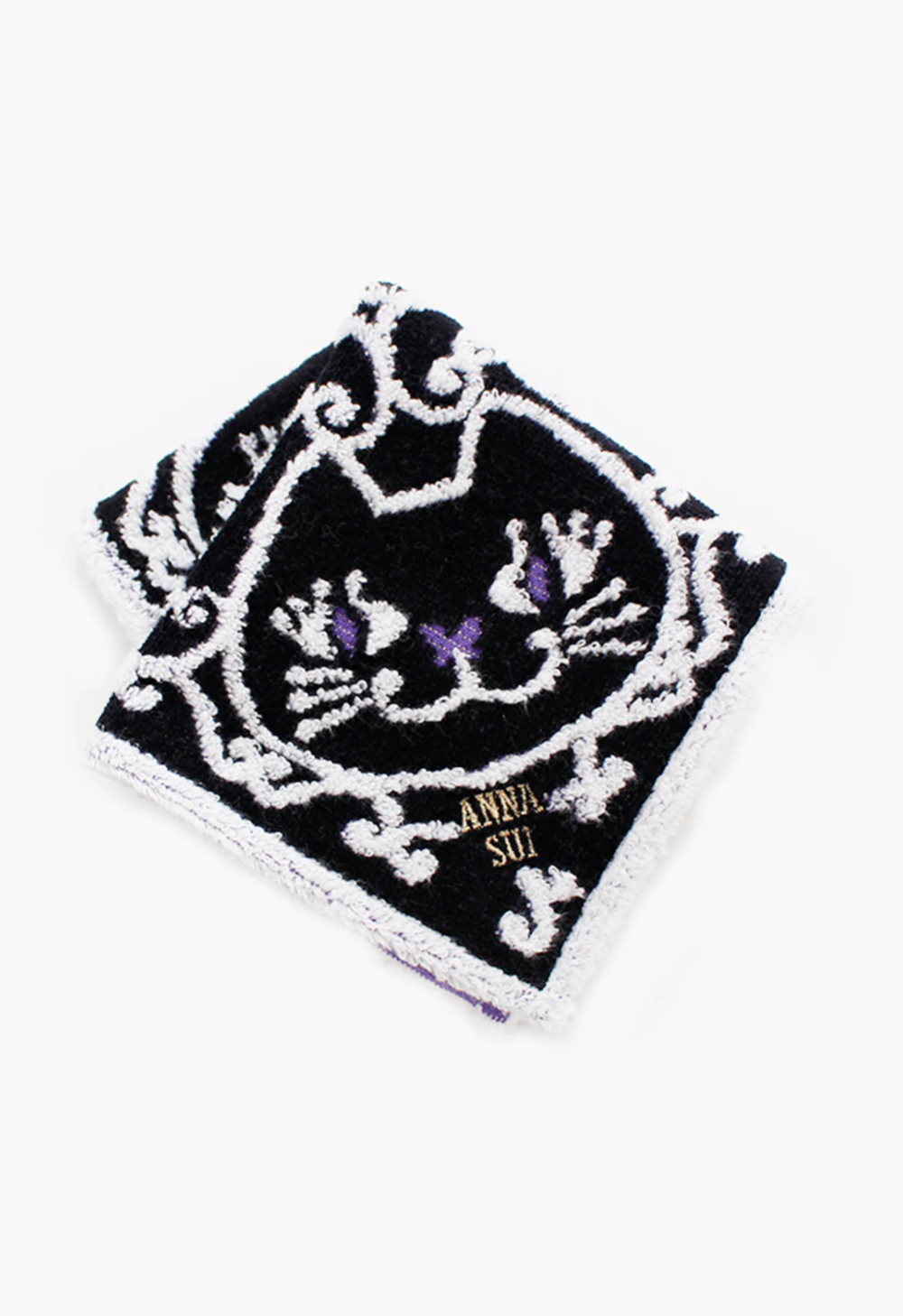 Cat Pattern Washcloth in black, detail of white/purple cat pattern, Anna Sui's label in the corner