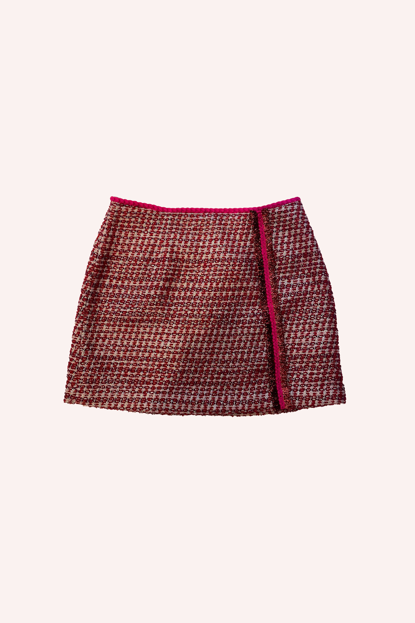 This ruby-colored, tweed mini-skirt, a red highlight at the top hem and on the left side, goes from the top to the hips