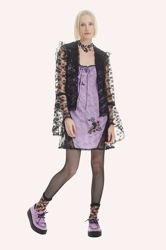 Sleeveless lavender dress, black lace shoulders straps and hems, mid-thigh, a lavender ribbon collar