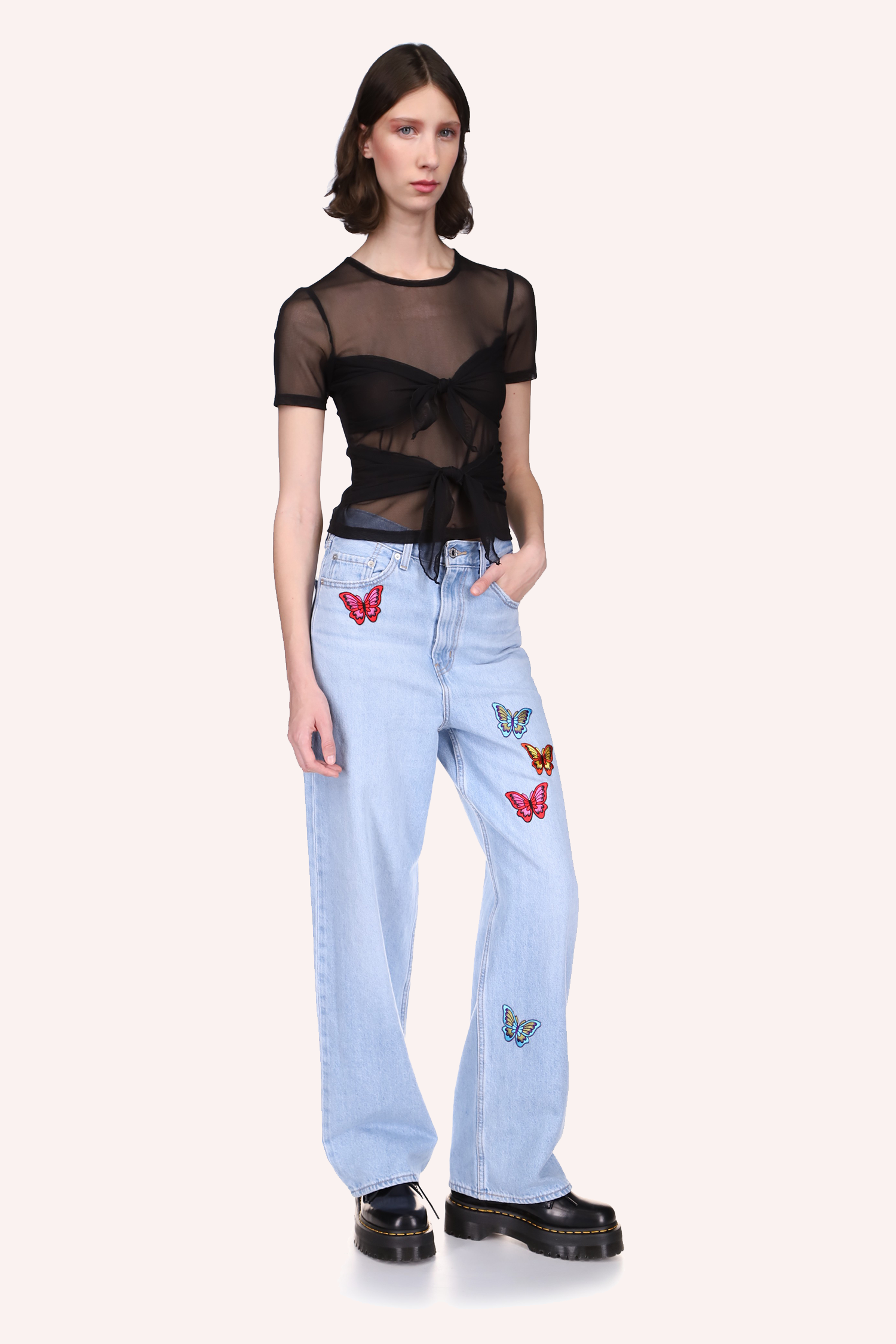 The Jenny Top Black has a crew neck and is highlighted with dark black stitching