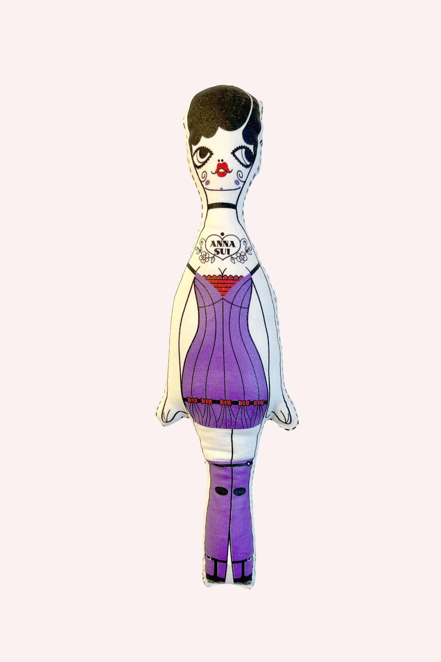 Anna Sui Doll Purple, stylized like a Russian doll, Anna Sui logo on torso, attire in purple