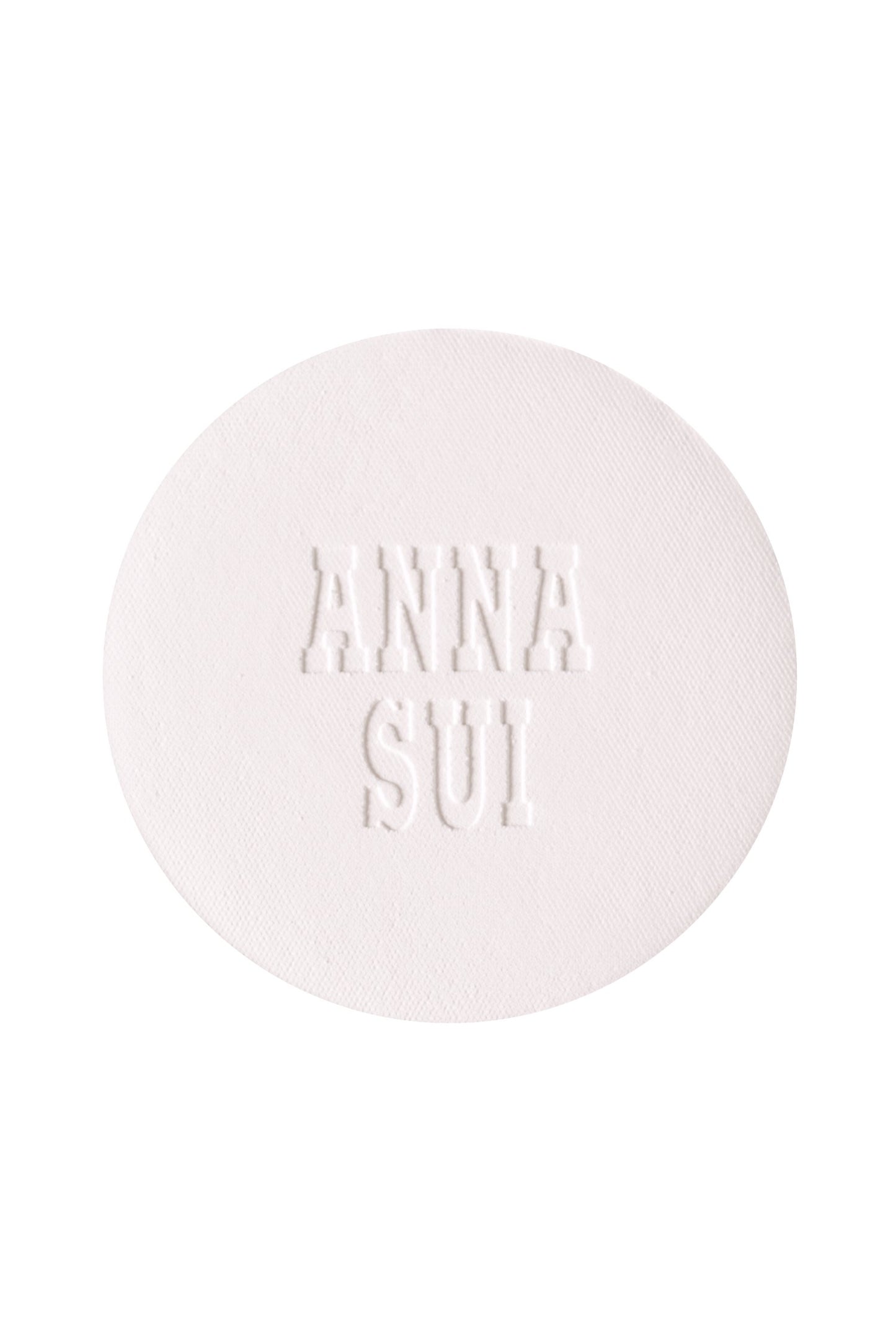 A round powder refill with engraved Anna Sui.
