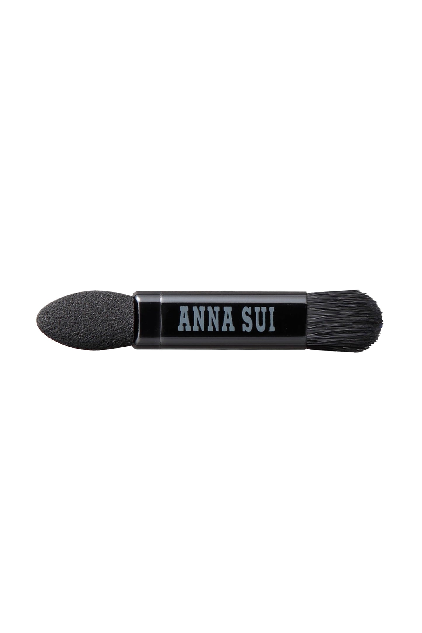 The applicator, a hard head on one side, a Bruch on the other, Anna Sui label on the middle of it
