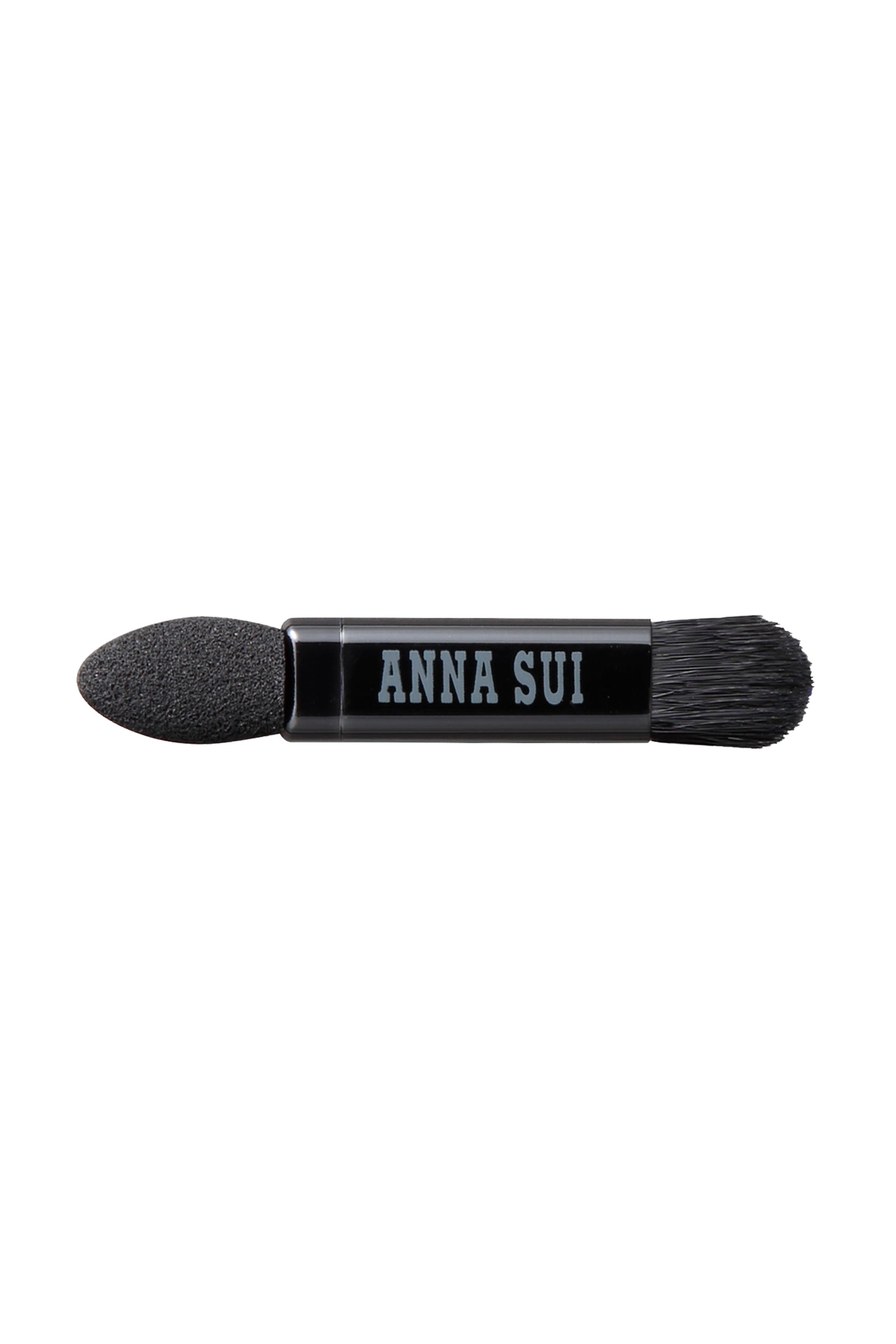 The applicator, a hard head on one side, a Bruch on the other, Anna Sui label on the middle of it