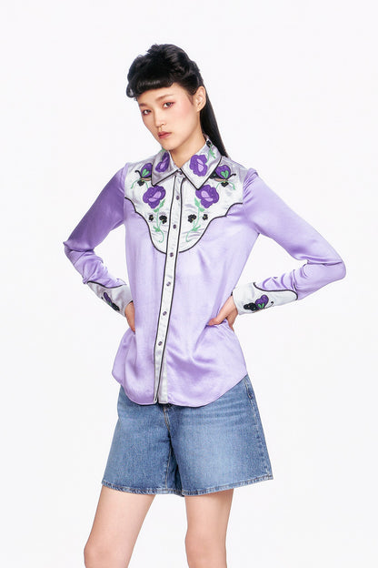 Woman wearing a Purple Boudoir Satin wavy Floral Embroidered and denim shorts