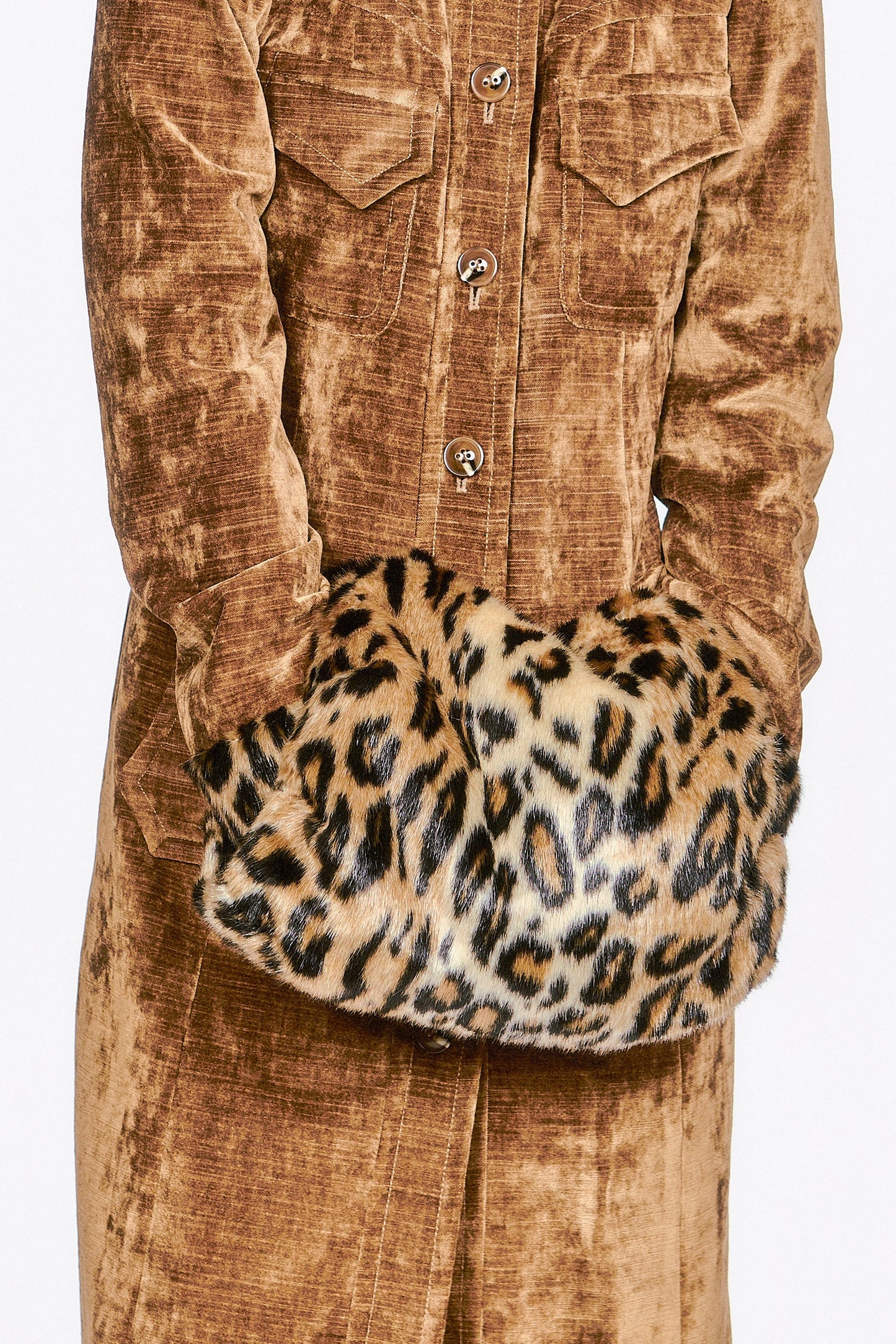 Faux Leopard Muff, animal-friendly fabric, it’s a cozy and glamorous accessory for chilly days.