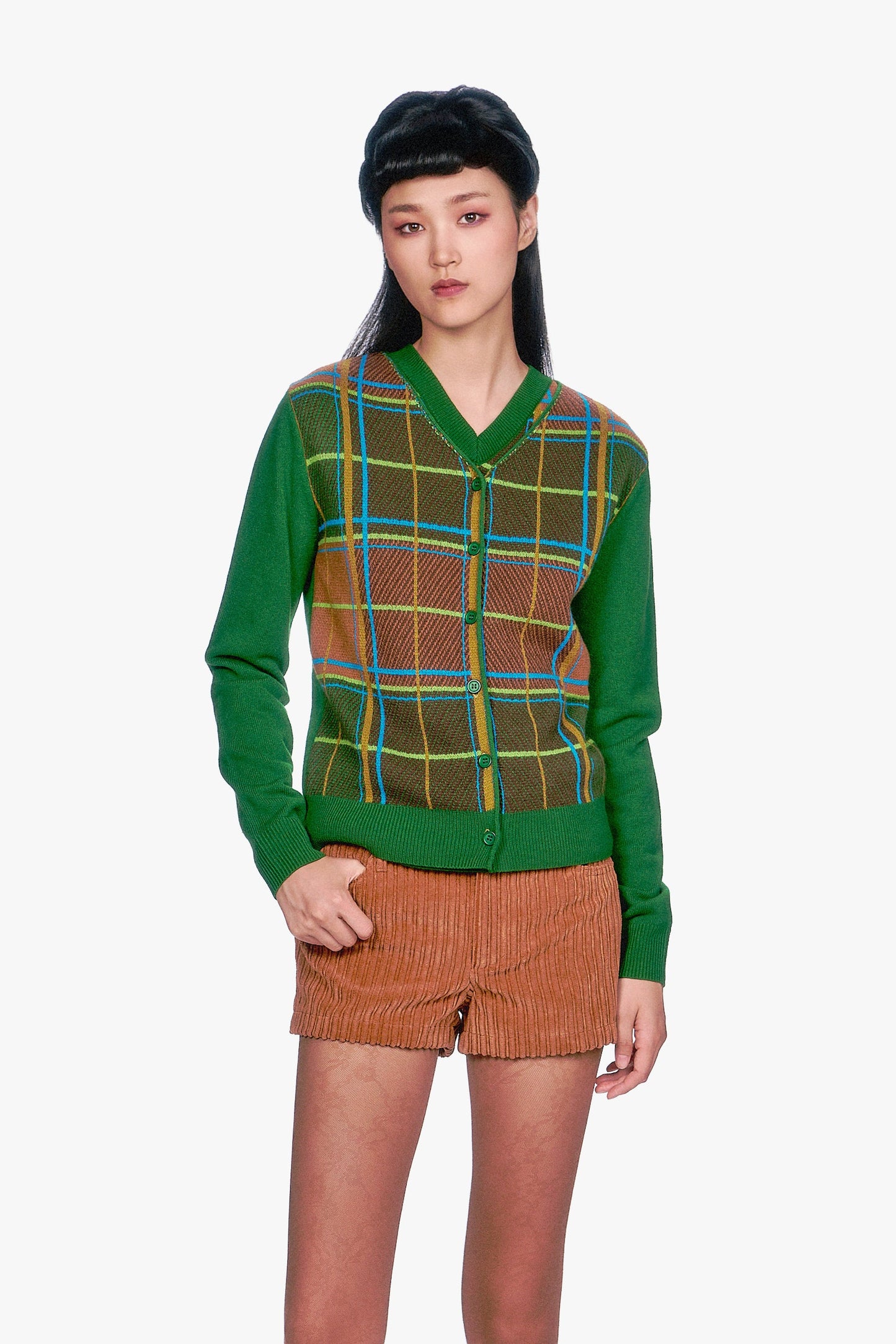 Woman wearing a Long Sleeves Plaid Cardigan - Leaf Green top and beige pleated skirt.