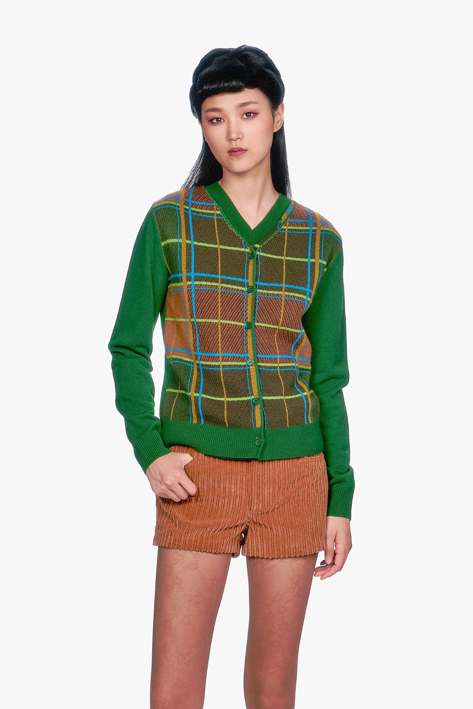 Woman wearing a Long Sleeves Plaid Cardigan - Leaf Green top and beige pleated skirt.