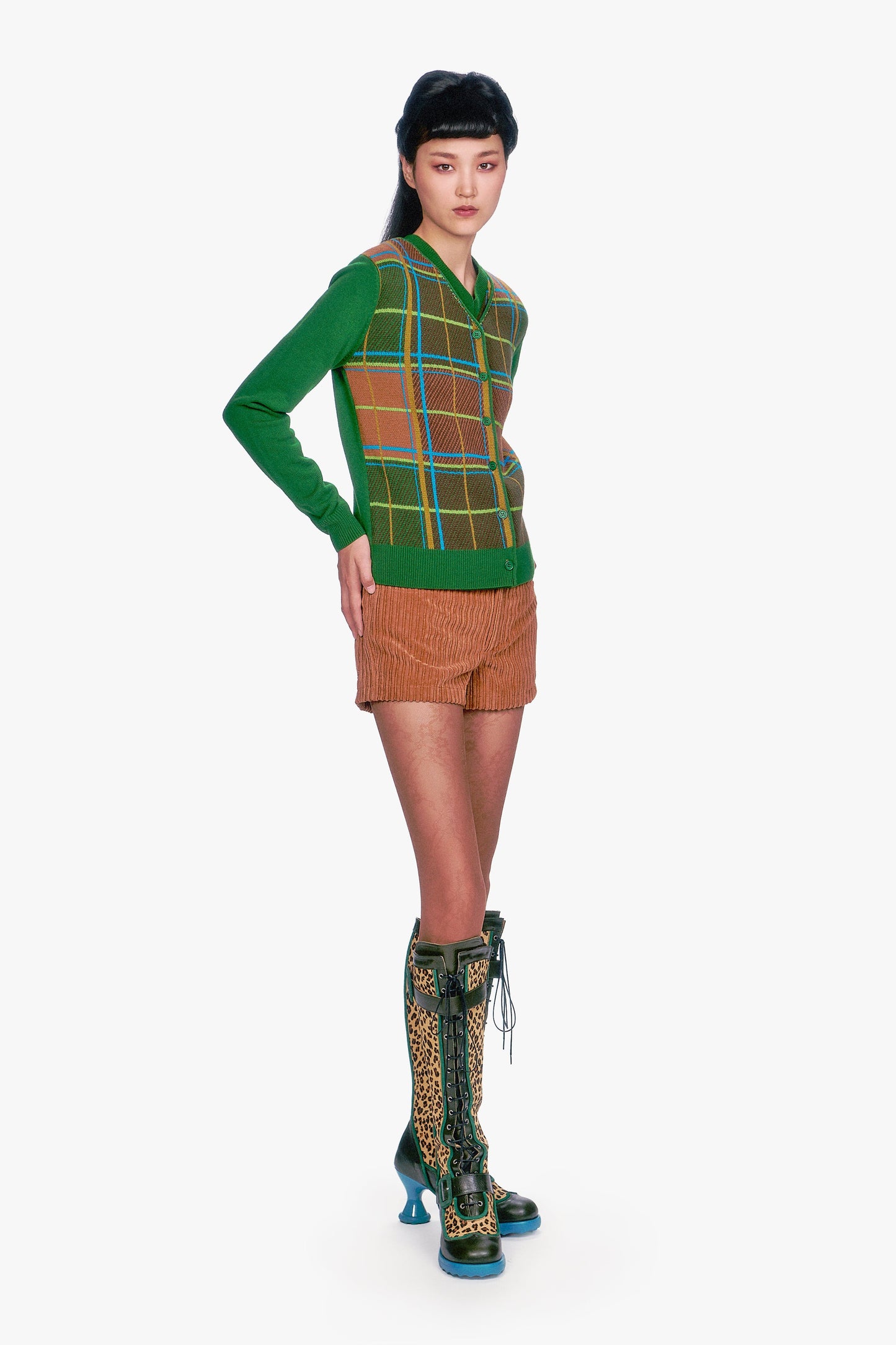Model wearing Long Sleeves Plaid Cardigan - Leaf Green, brown shorts, and patterned boots