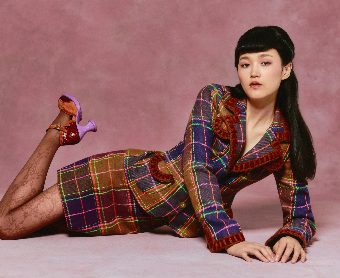 Bold meets classic in this mini skirt featuring a caramel base with vibrant magenta plaid. 