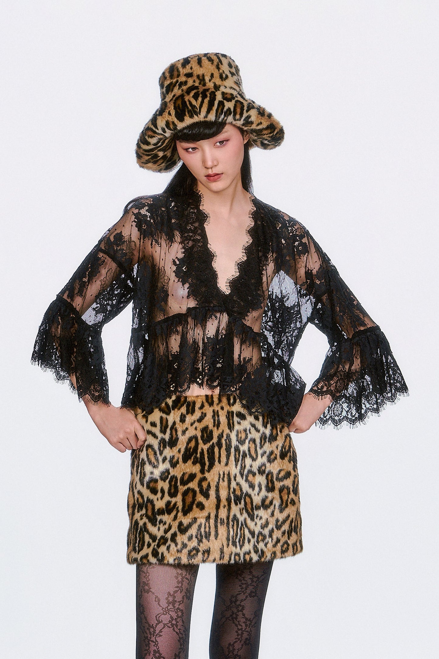 The Victorian Lace V-Neck Top in black features delicate lace accents and a flowy silhouette. 