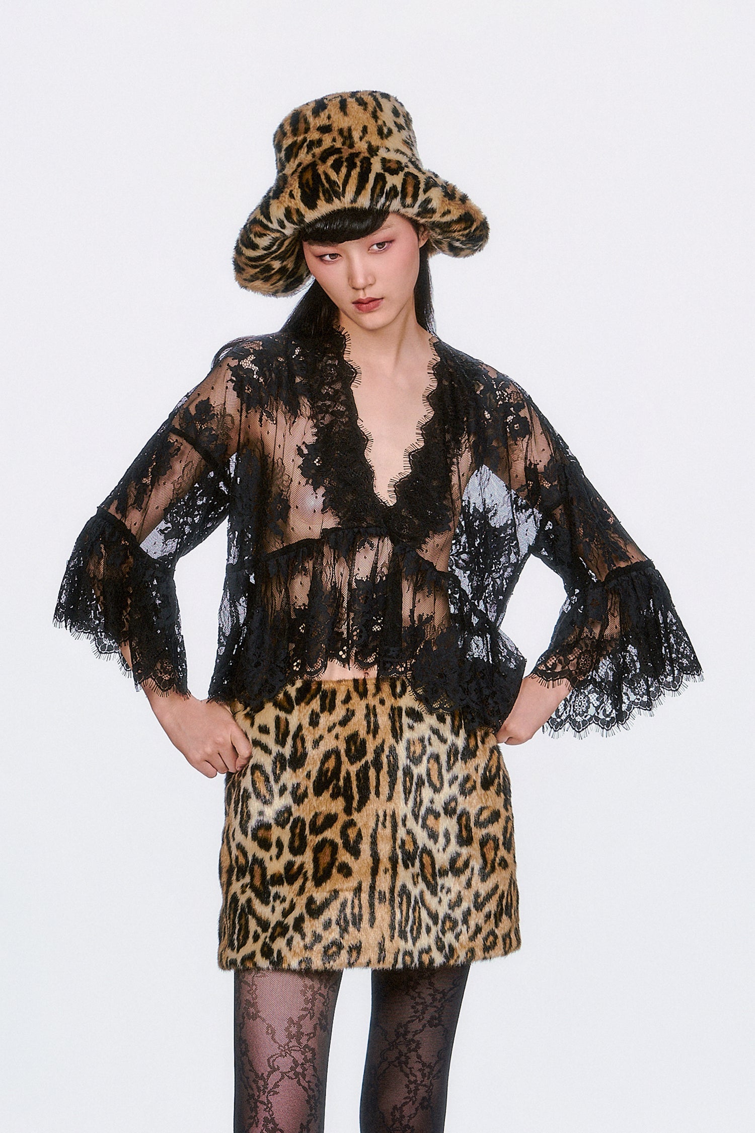 The Victorian Lace V-Neck Top in black features delicate lace accents and a flowy silhouette. 