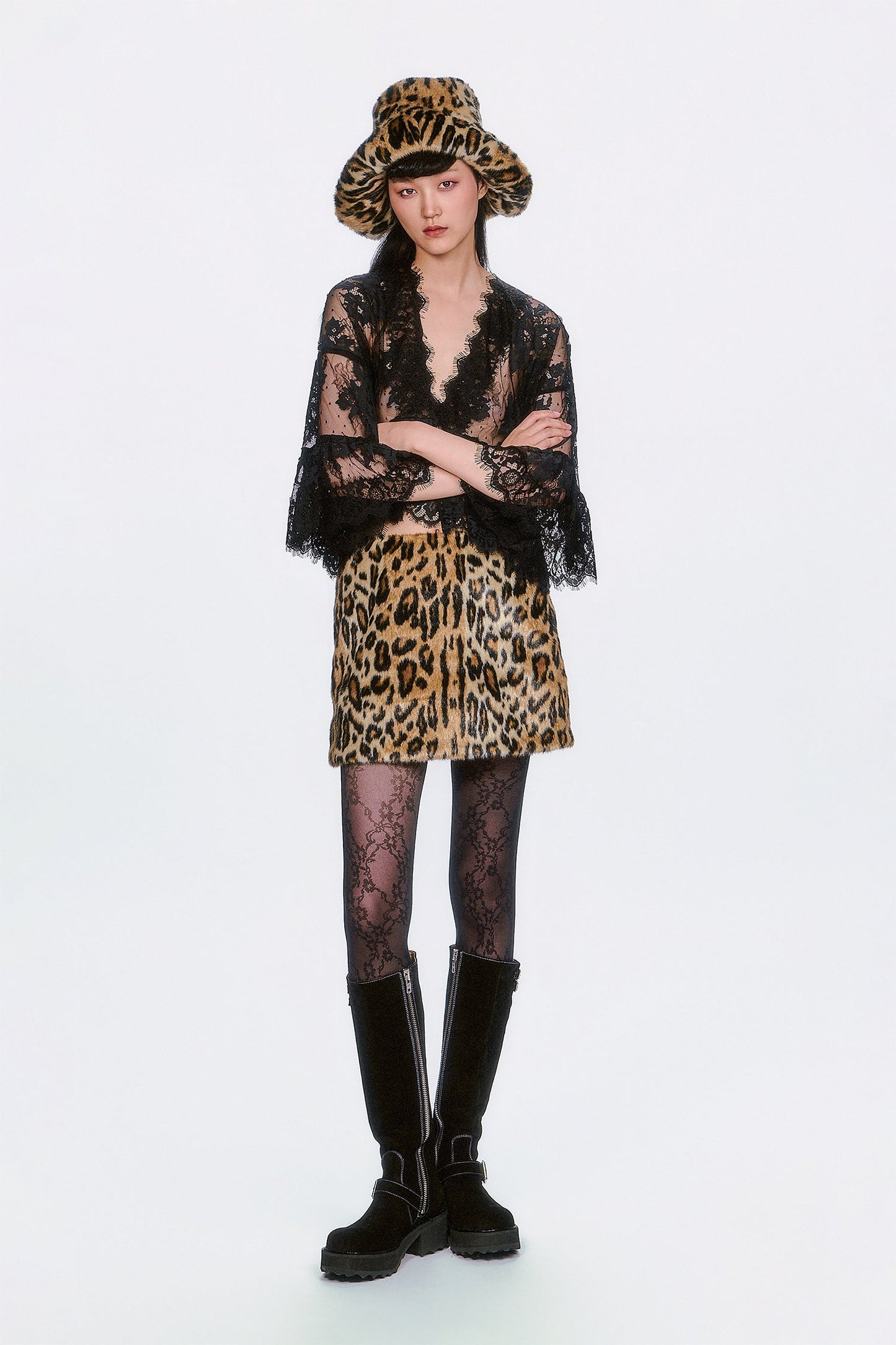 Person wearing a Faux Leopard Mini Skirt outfit with hat, boots statement edge to both Stylish and Sweet.