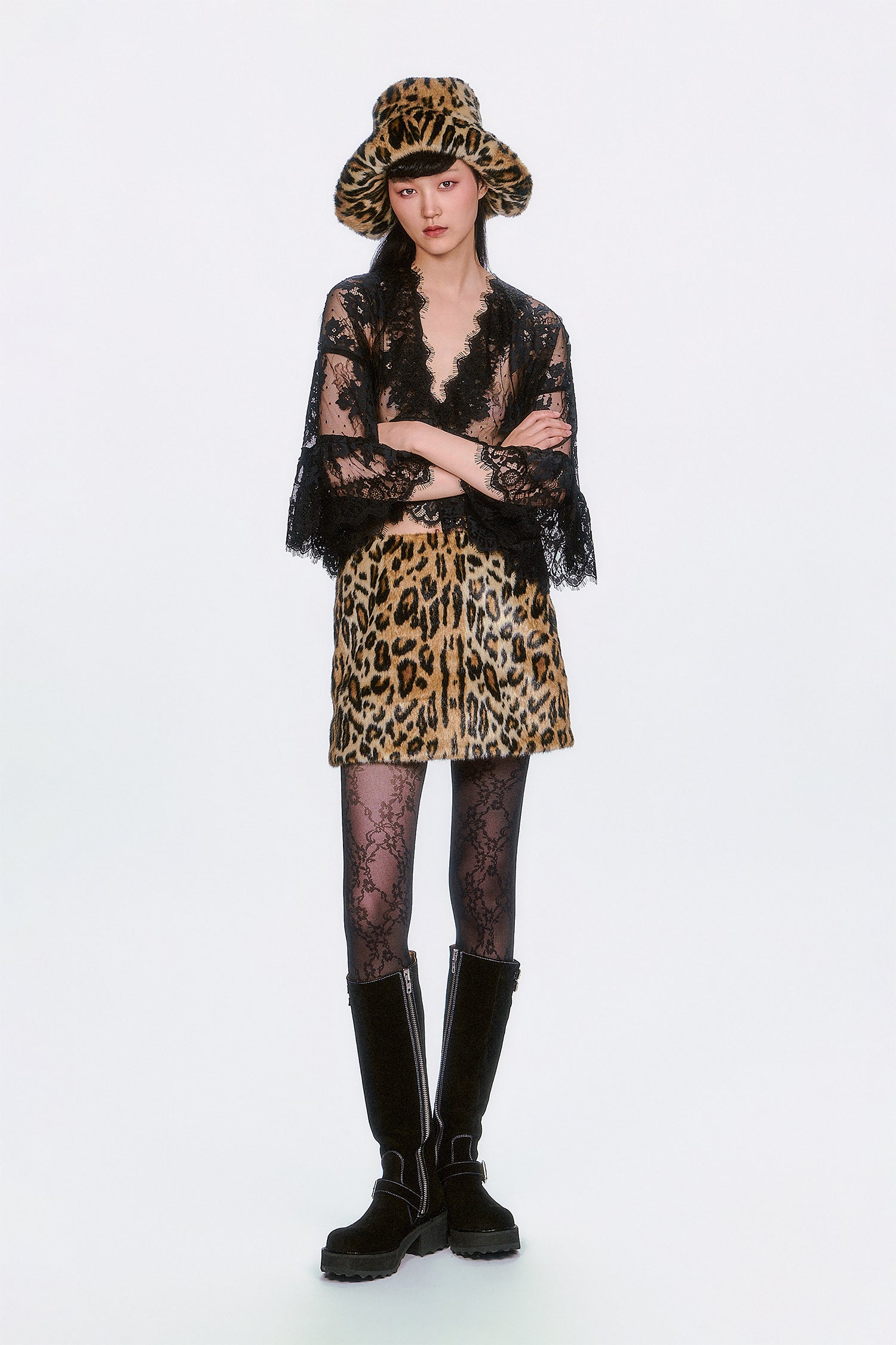 Person wearing a Faux Leopard Mini Skirt outfit with hat, boots statement edge to both Stylish and Sweet.