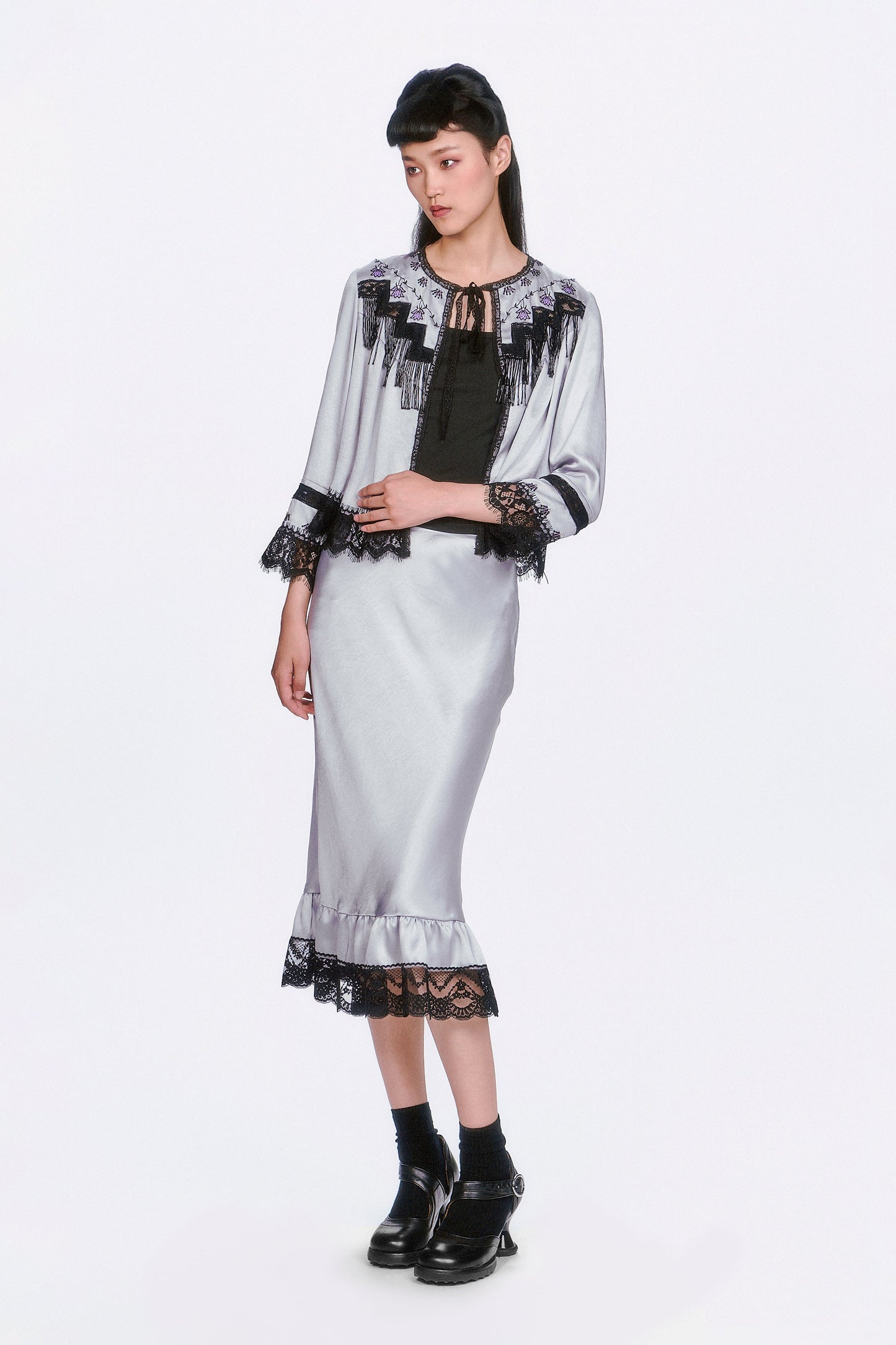 Boudoir Satin Beaded Fringe Bed Silver Jacket paired with a same pattern silver skirt.