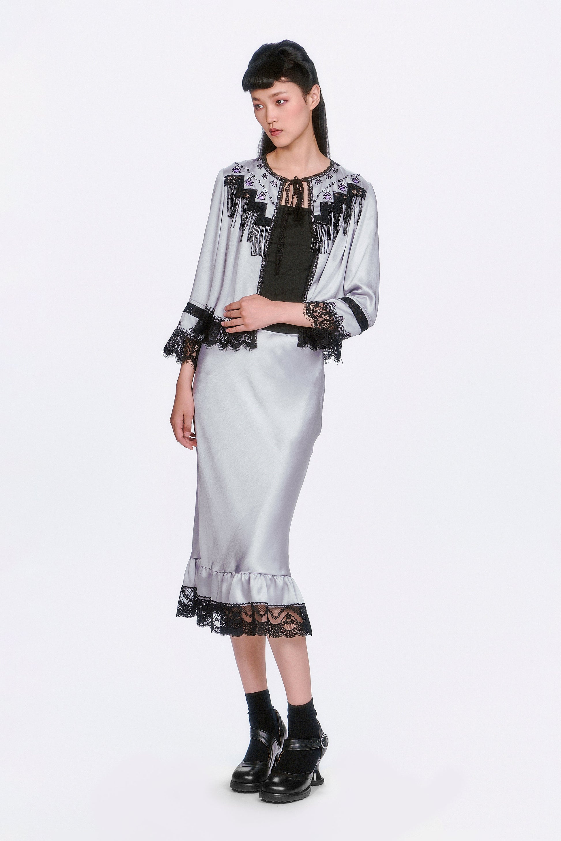 Boudoir Satin Beaded Fringe Bed Silver Jacket paired with a same pattern silver skirt.