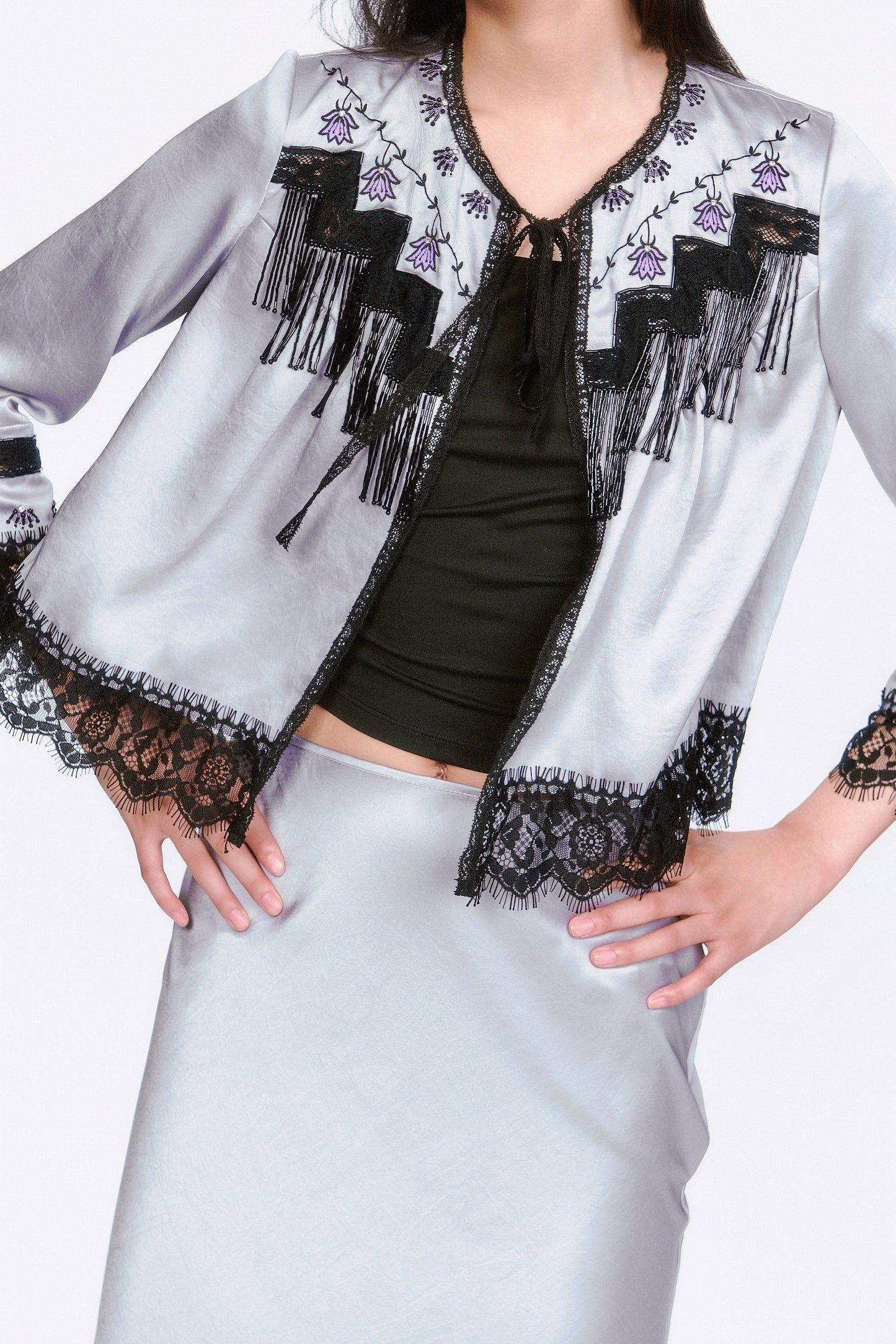 Boudoir Satin Beaded Fringe Bed Silver jacket with black lace and fringe details, black ribbon at collar.