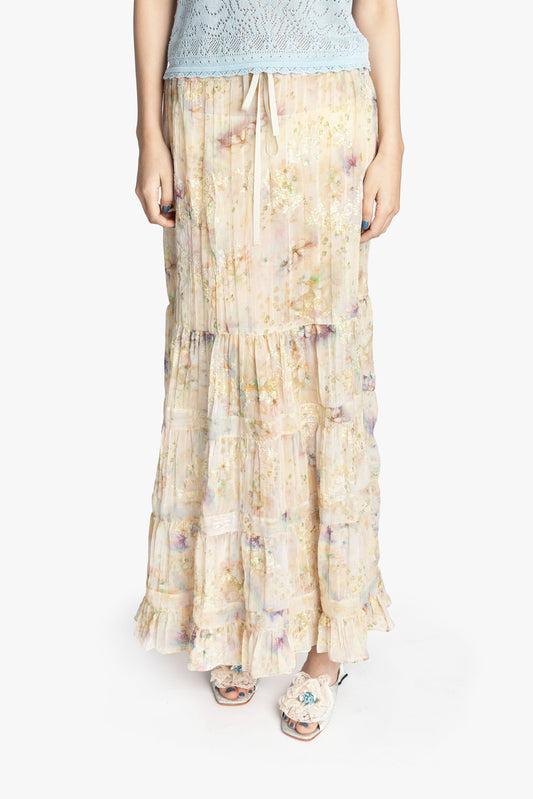 Person wearing a floral long skirt on a white background