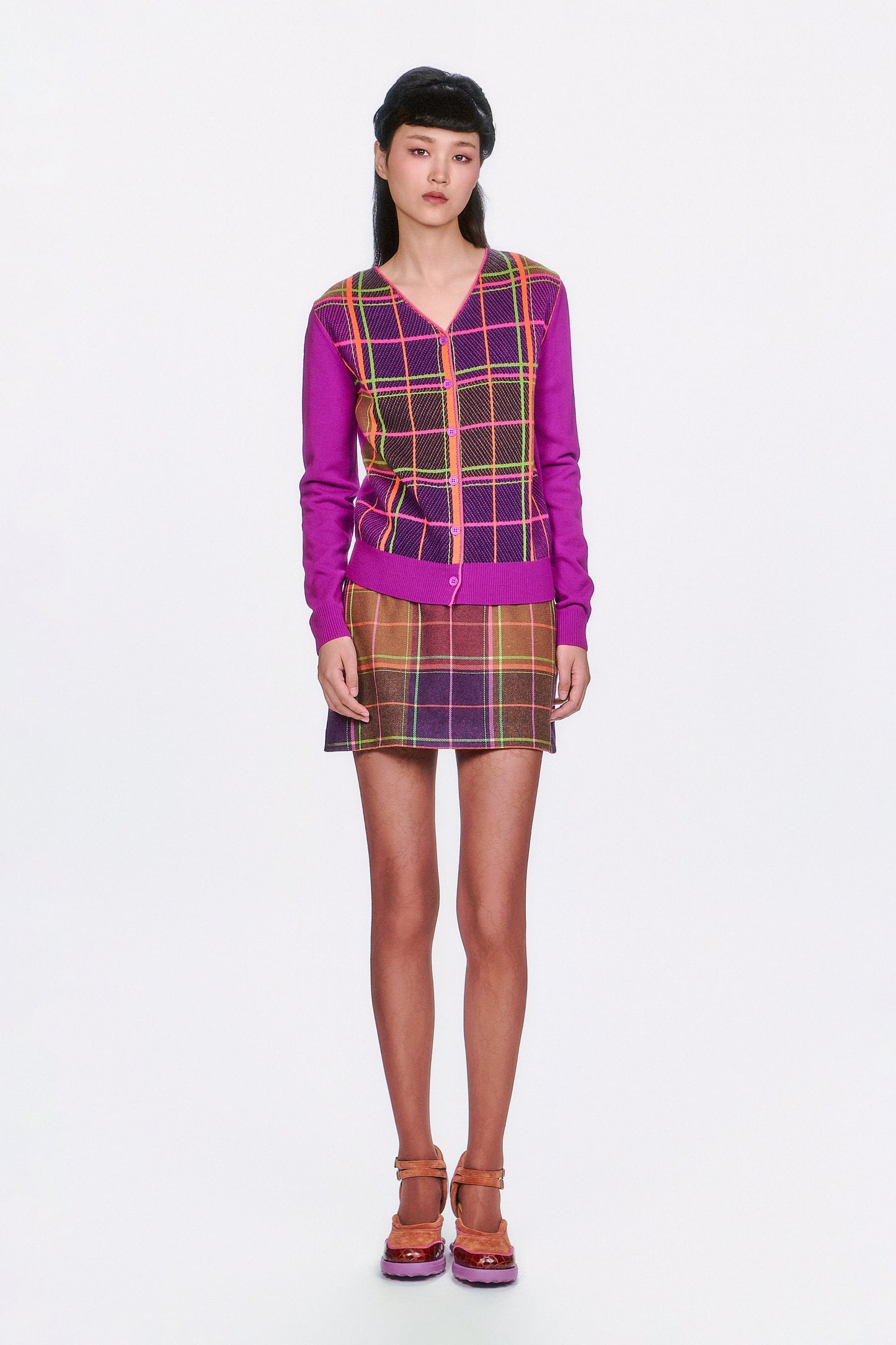 Person wearing a Plaid Cardigan – Magenta, mini skirt same pattern, and shoes. 