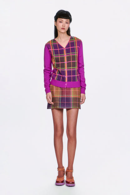 Person wearing a Plaid Cardigan – Magenta, mini skirt same pattern, and shoes. 
