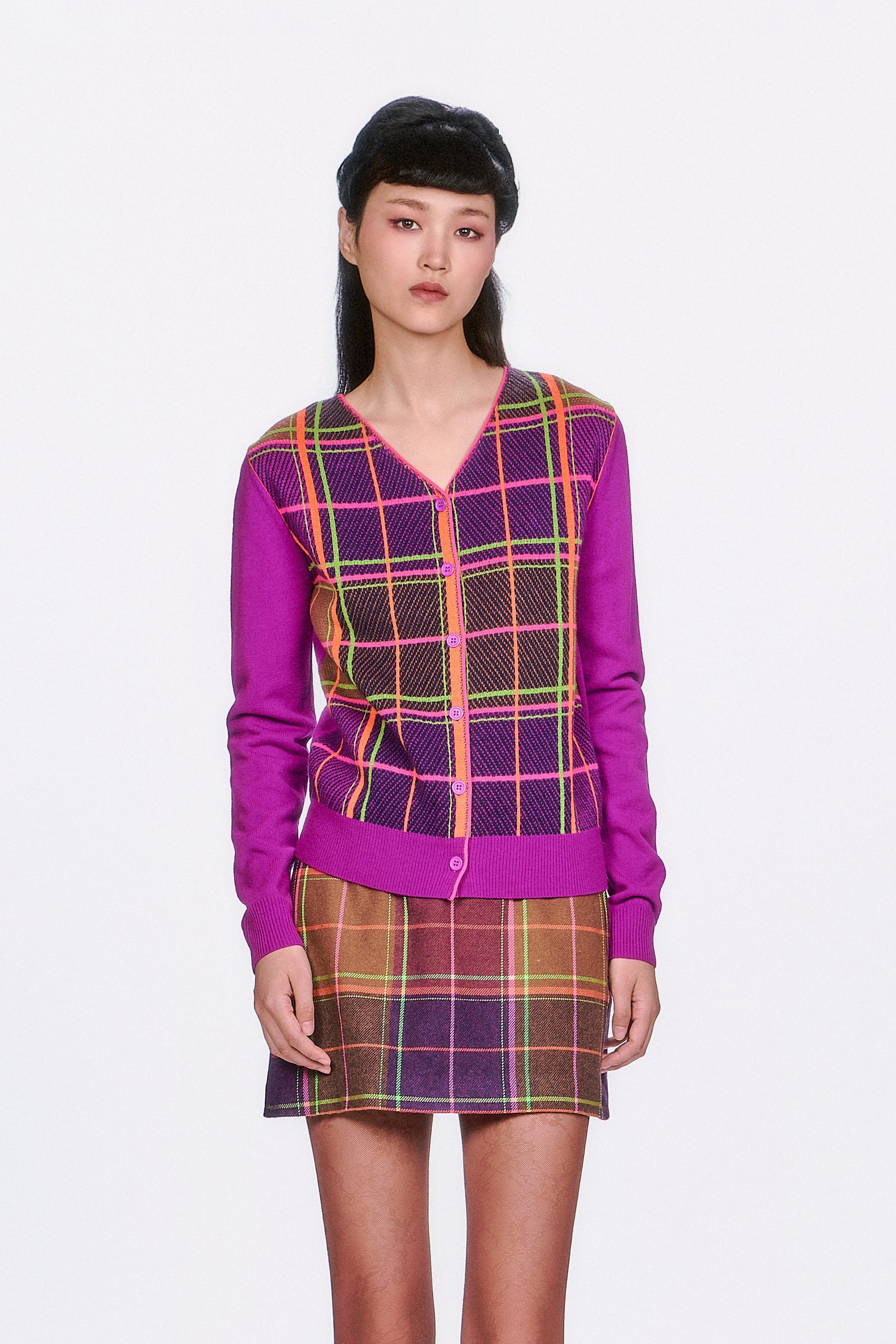 Woman wearing a Long Sleeves Plaid Cardigan – Magenta top and Plaid Magenta pleated skirt