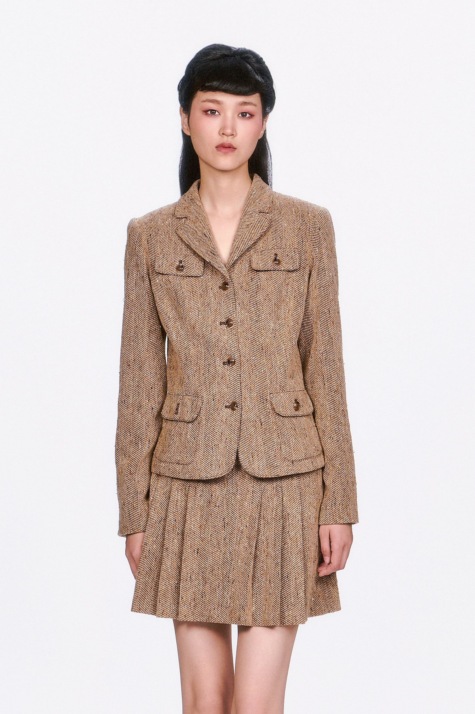 Structured and sophisticated, the Herringbone Jacket features a timeless pattern and a sharp, tailored fit. 