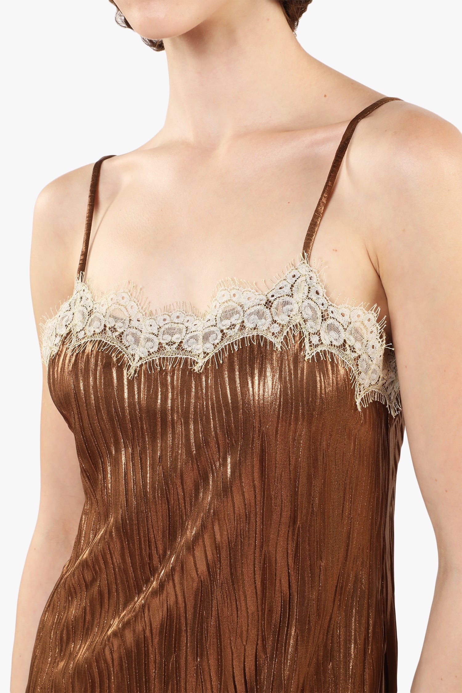 Details of Pleats Slip bronze Dress, sleeveless, white lace highlight the curves above the bust.