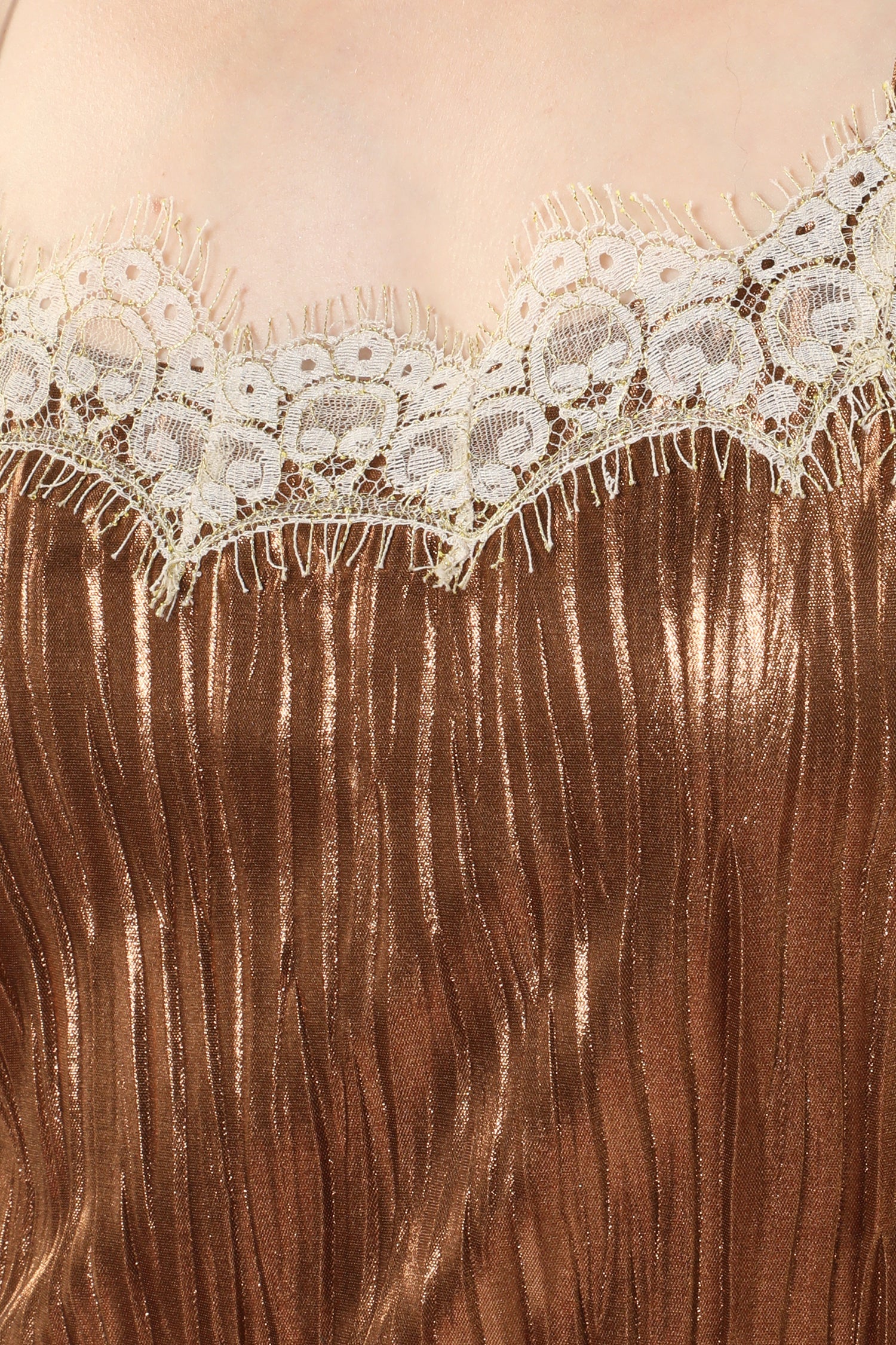 Details of Pleats Slip bronze Dress; white lace highlight the curves above the bust.