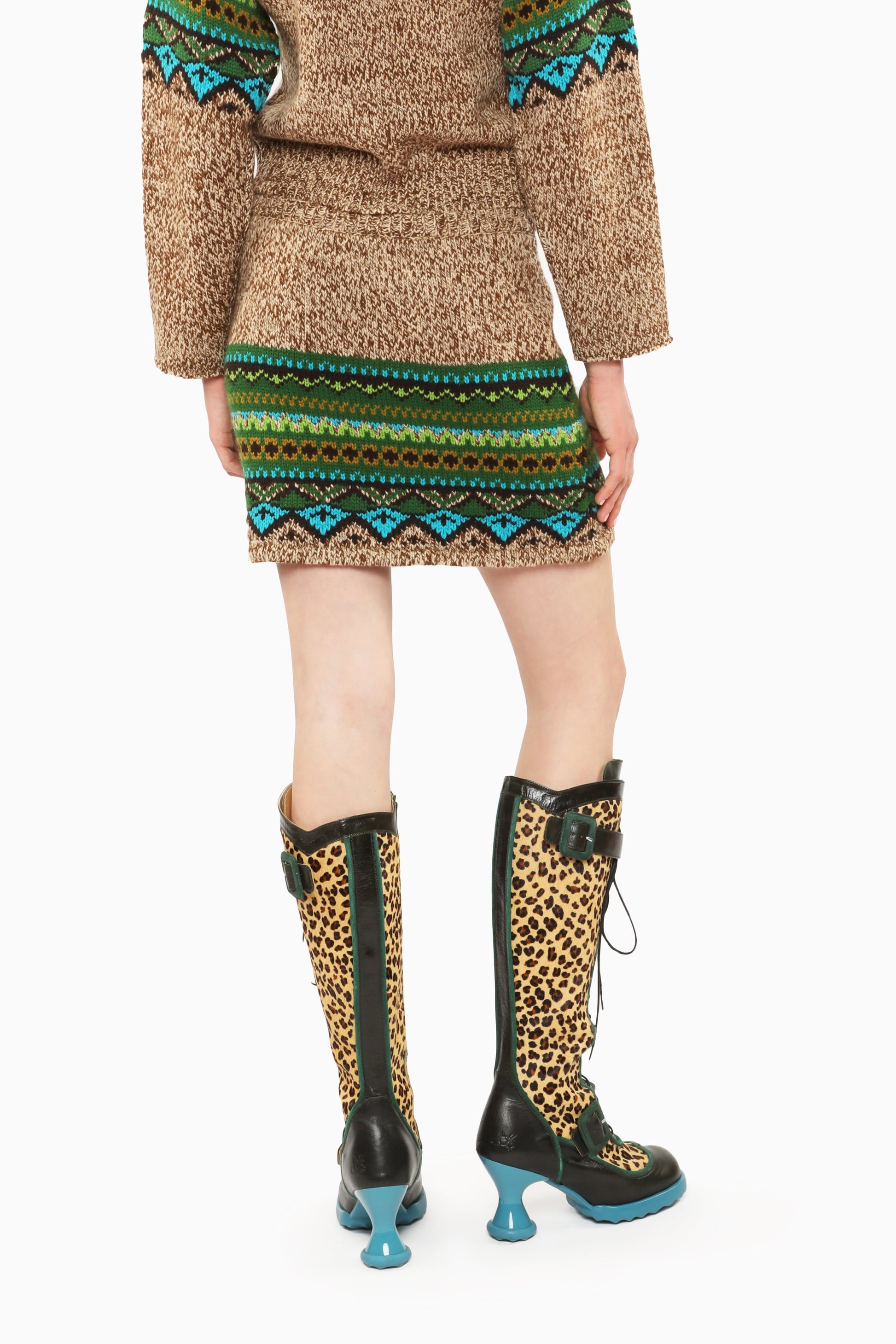 Fair Isle Mini Skirt – Teal with pattern hue of green and blue triangles mini skirt with knee-high boots.