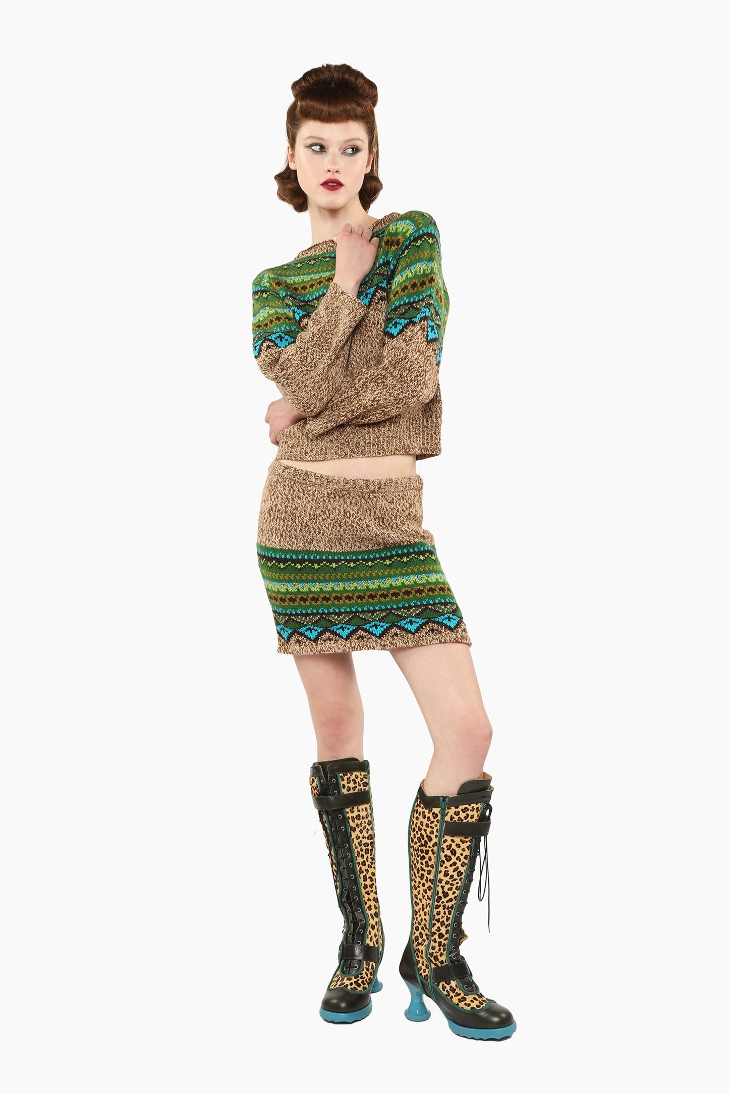 Woman wearing Fair Isle Sweater – Teal and matching skirt set with knee-high boots