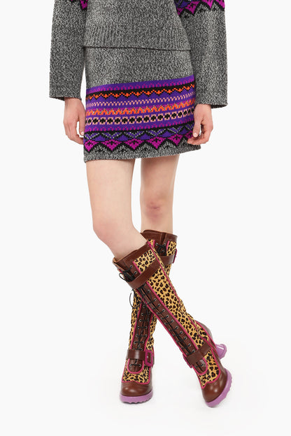 Fair Isle Mini Skirt – Magenta with lines green and purple triangles mini skirt with knee-high boots.