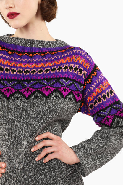 Close-up of a gray knitted cardigan with colorful Magenta patterned hem and cuffs.