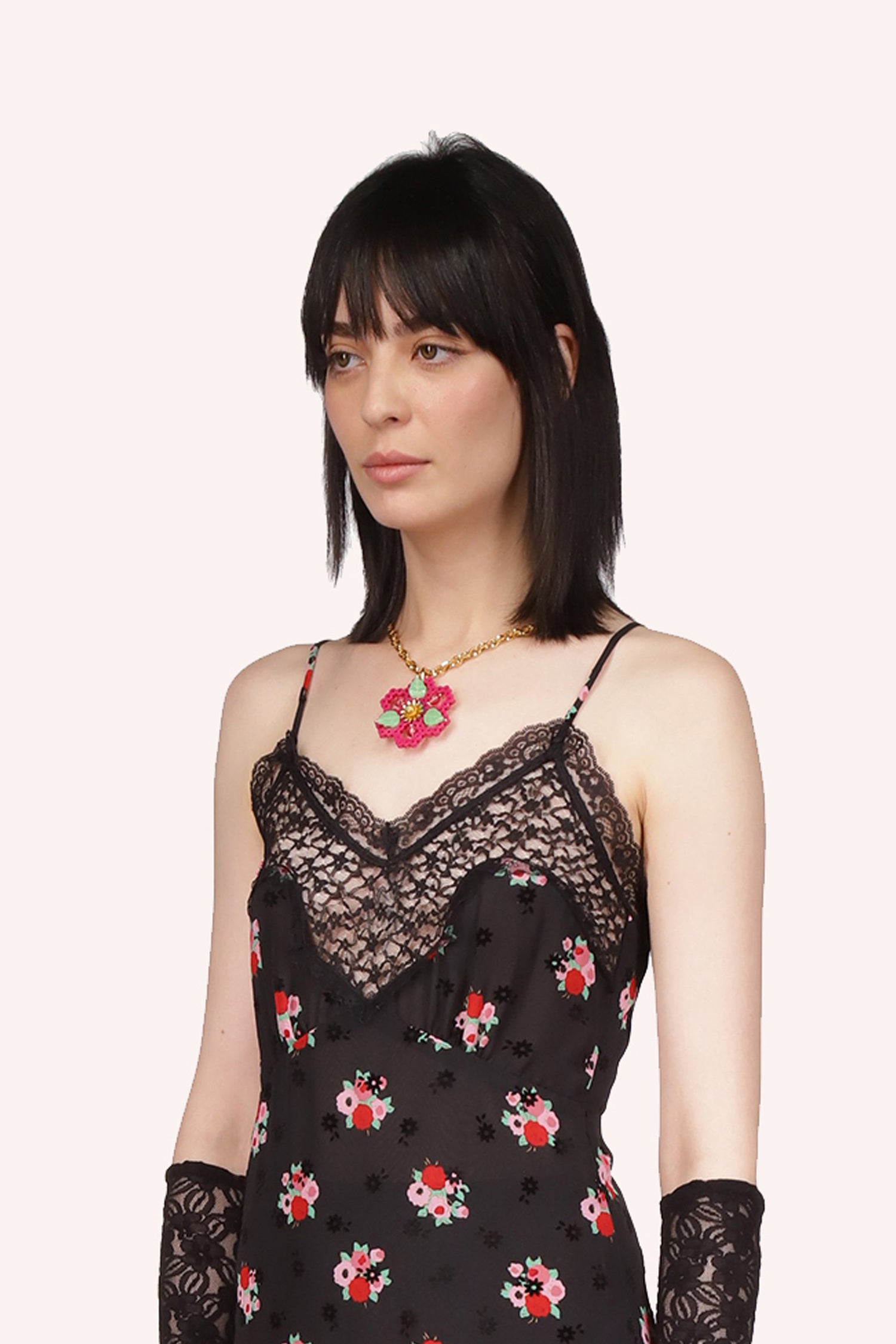 The Anna Sui Daisy Chains Necklace Berry Multi is a hexagonal medallion design with a golden chain secured by an S-hook