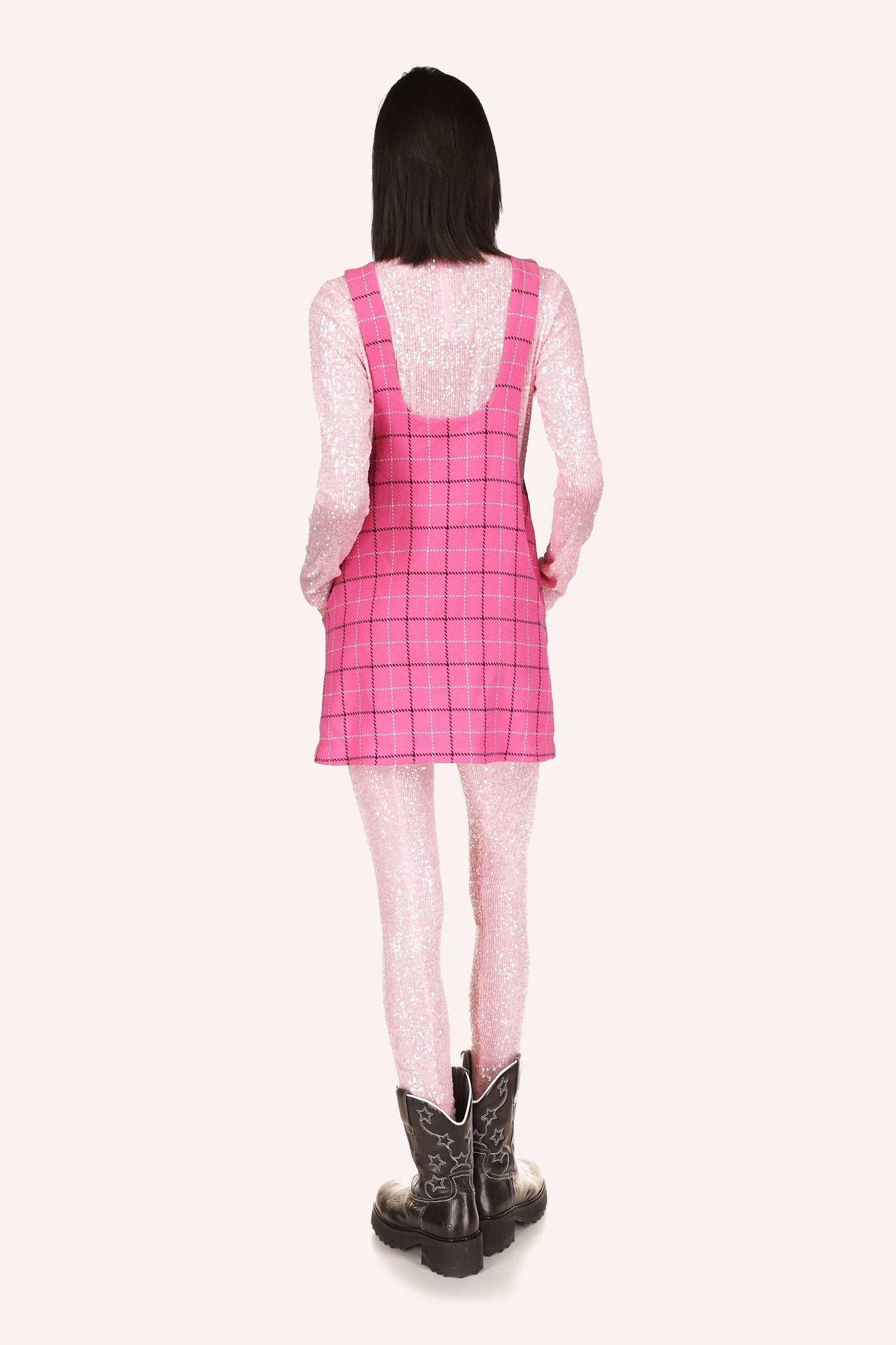 The girl looks stylish in Anna Sui's Windowpane Jumper Bubblegum Multi pink mini dress