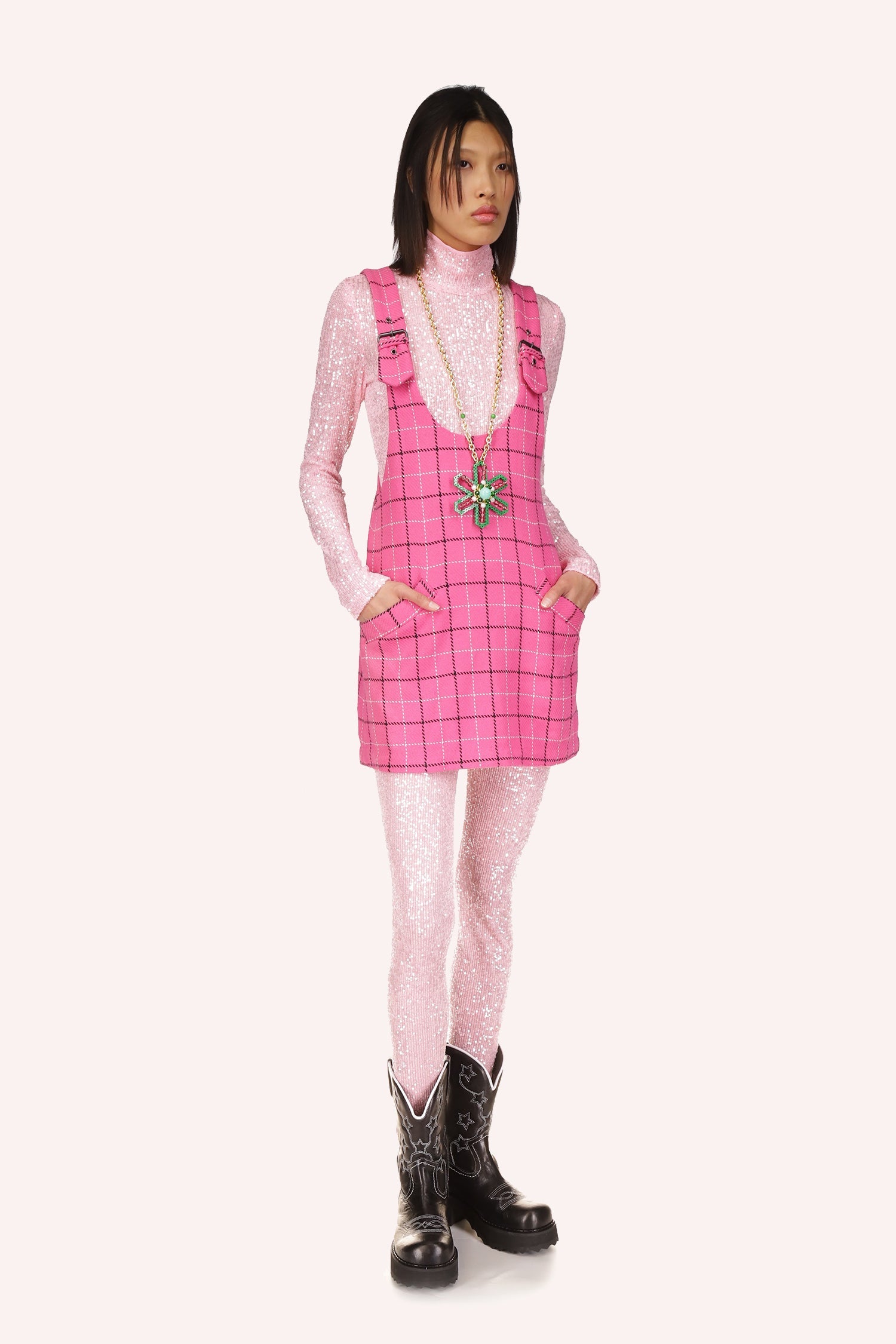 Sleeveless mini dress, deep cut collar, black/white squares pattern on pink, large buckles straps 