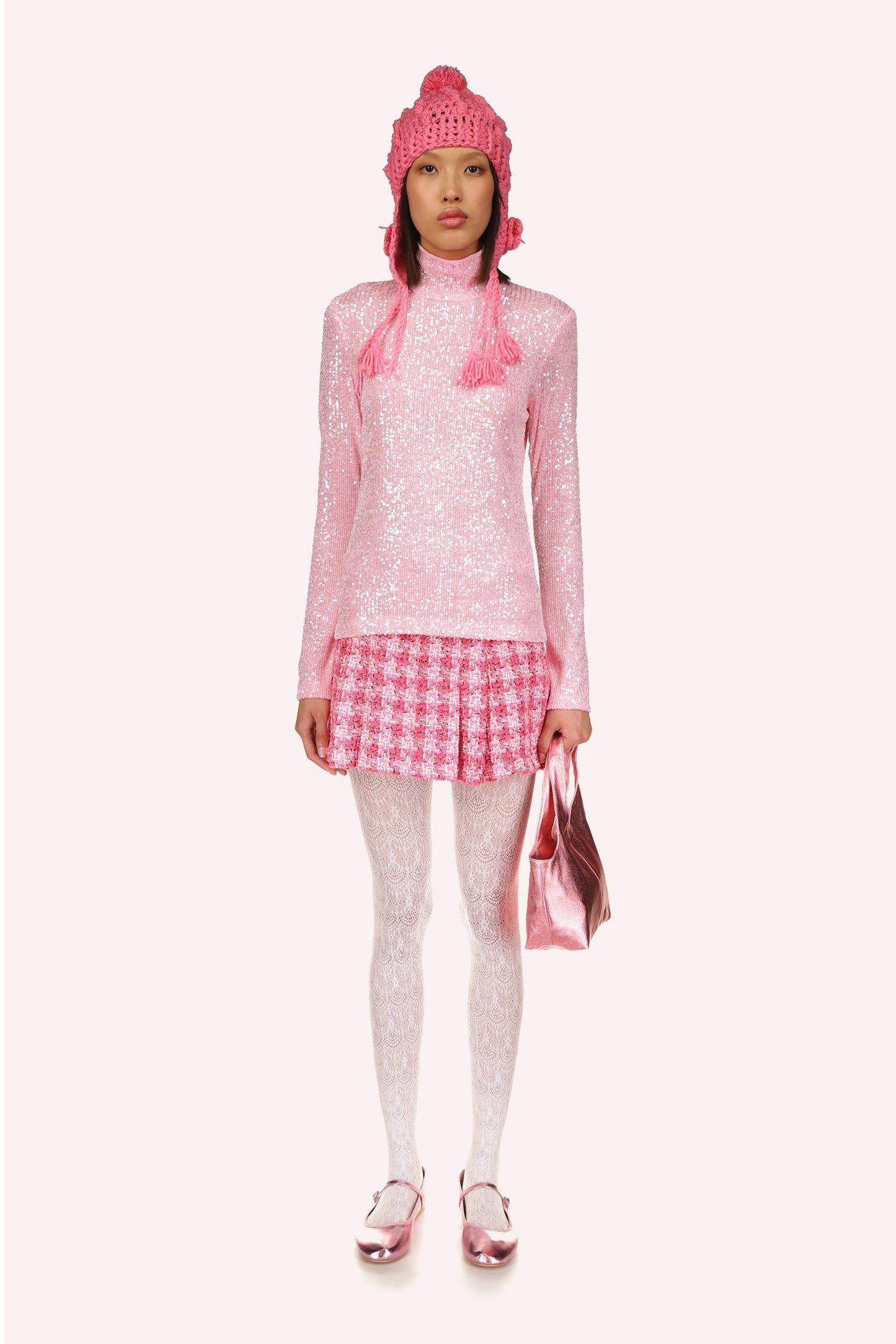 Sequin Mesh Turtleneck in Baby Pink beautifully accentuates the neckline while elongating the hips