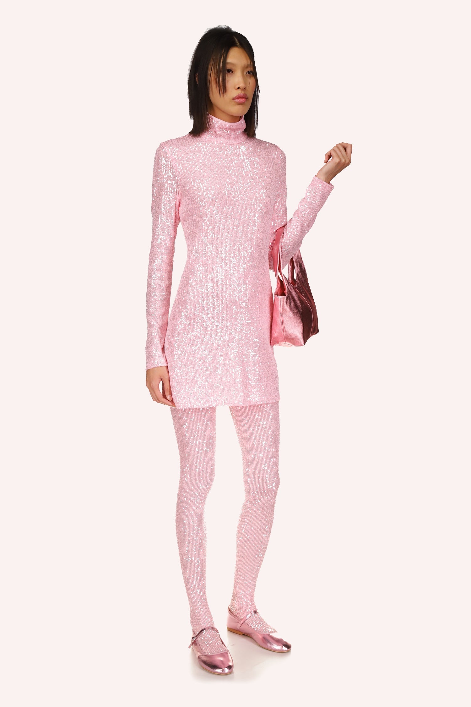 The Turtleneck Dress, offers an elegant and refined look in a delicate baby pink hue, long sleeves, turtle neckline collar