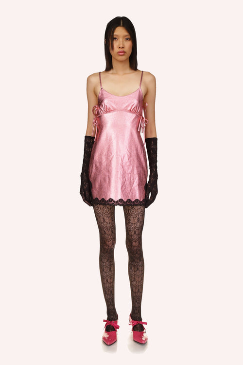 Bubblegum, sleeveless, deep cut on each side, 2-straps, wavy black lace at the bottom, pink grommets under the breast to adjust
