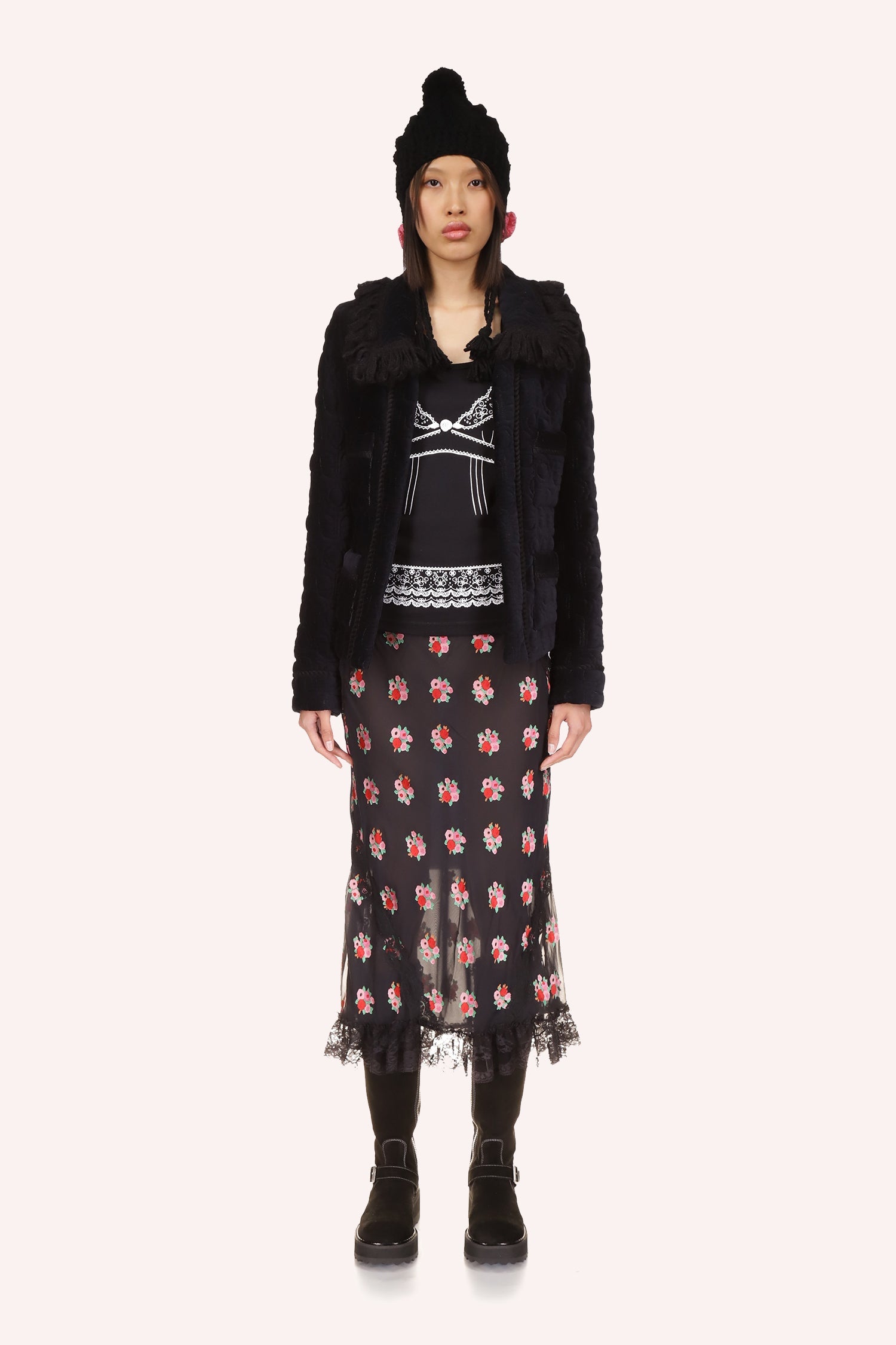 Black jacket, long-sleeves, large collar, 2-large pockets and shiny black opening and a repetitive, daisies-like pattern