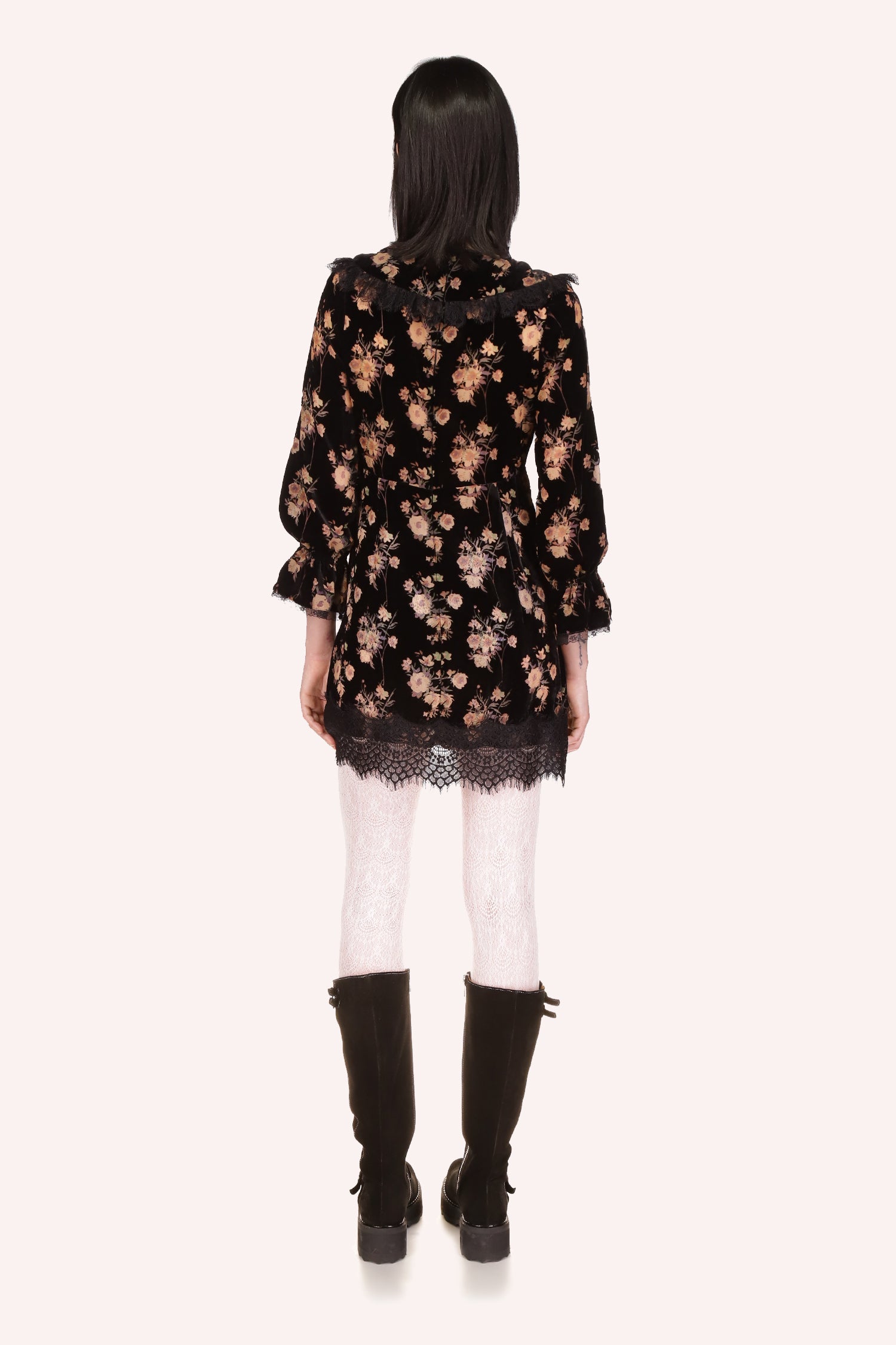 Black dress with beige floral bouquet pattern, V-shaped collar, long sleeves, and black lace at collar and hem